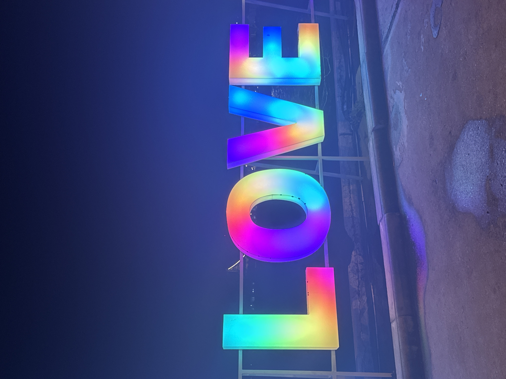 Rainbow LED love signs illuminate Koh Phangan Thailand night