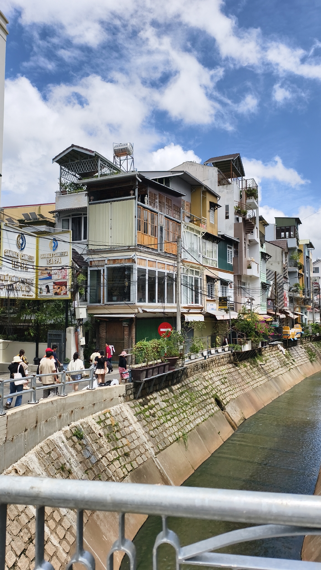 Da Lat's urban canal lined with colorful mixed-style buildings