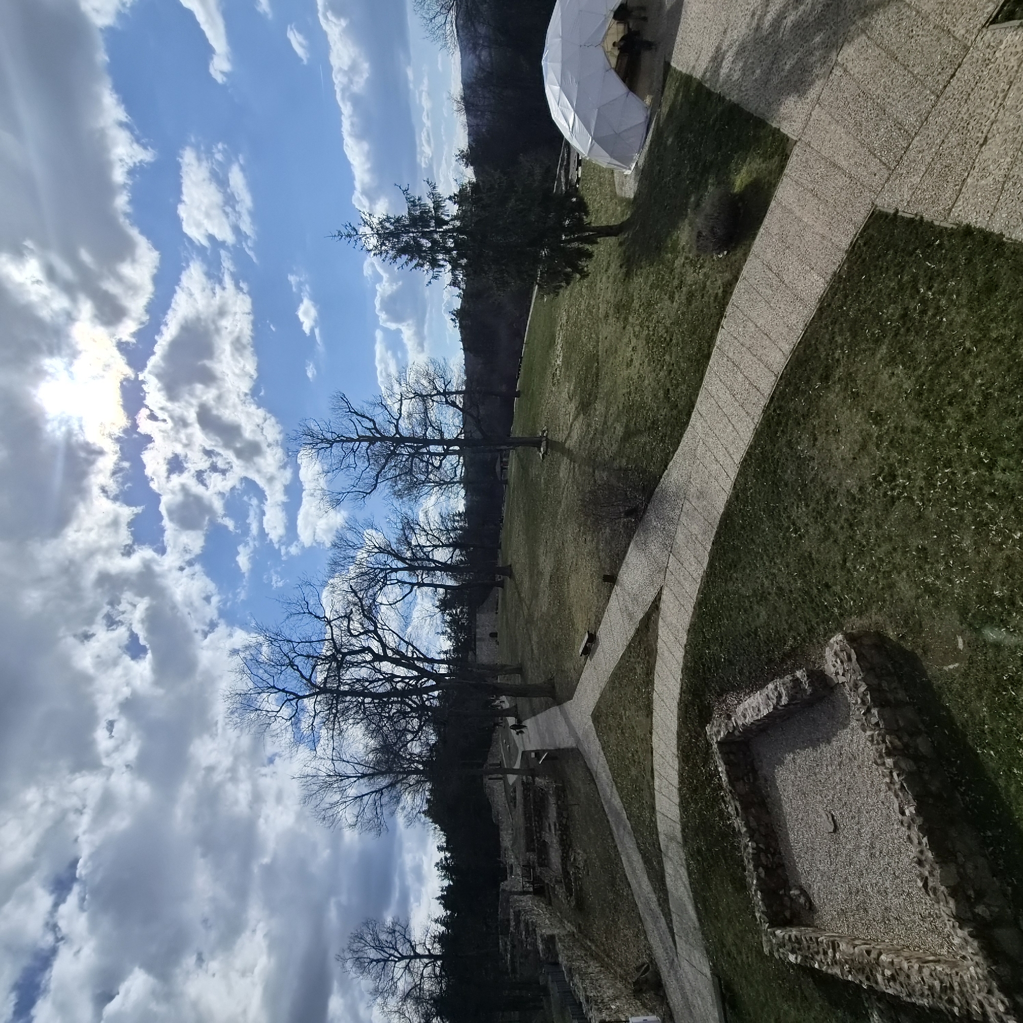 Visitor documents historical ruins and museum displays in Belchin