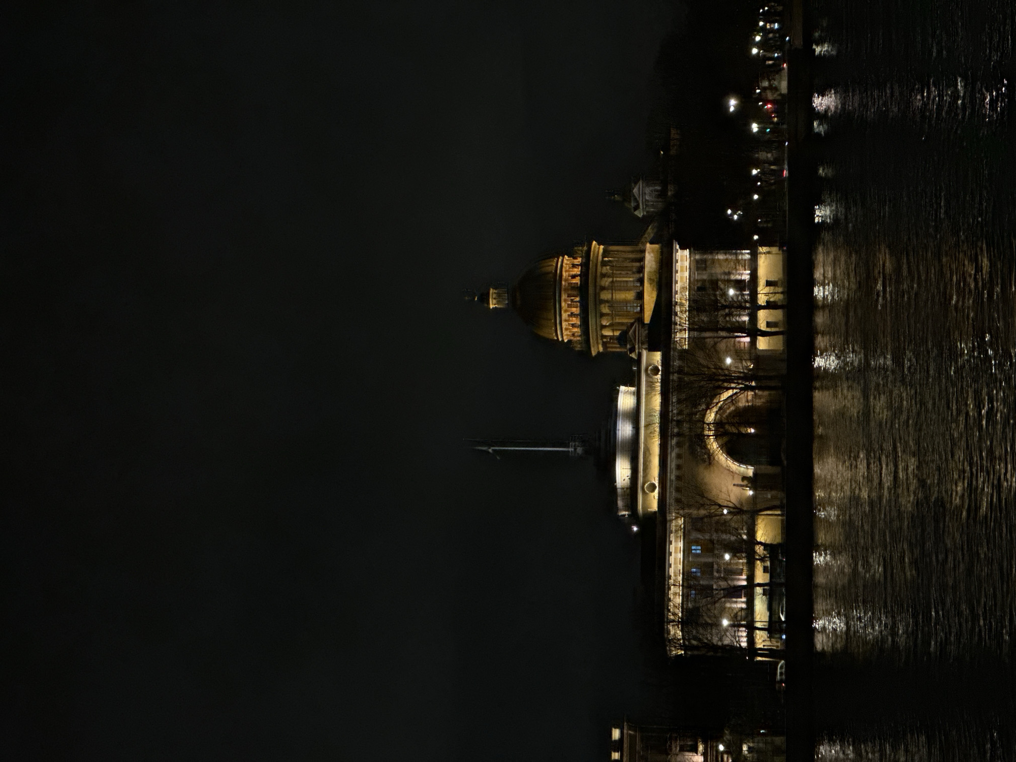 St. Isaac's Cathedral illuminated at night, reflected in waters