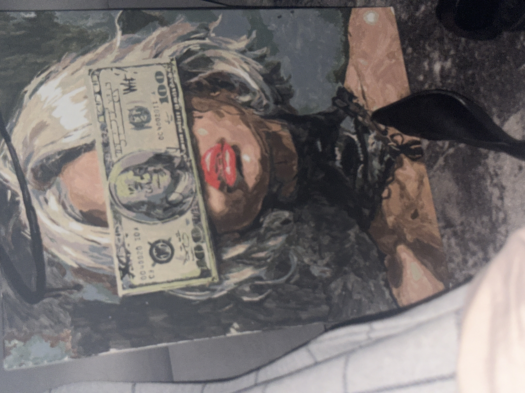 Russian witness documents portrait obscured by hundred-dollar bill, shoes