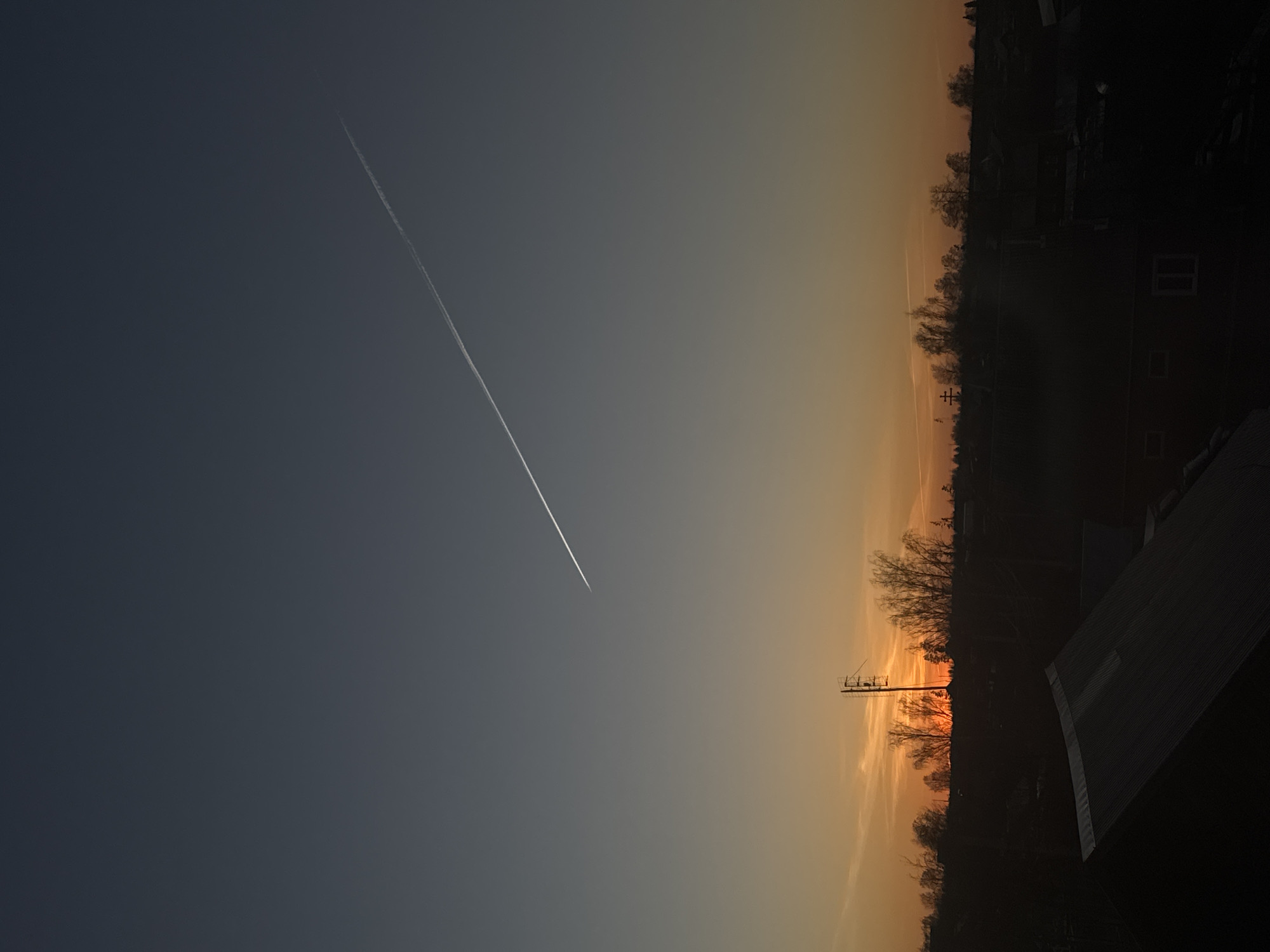 Sunset documented with contrail over Фоки, Russia