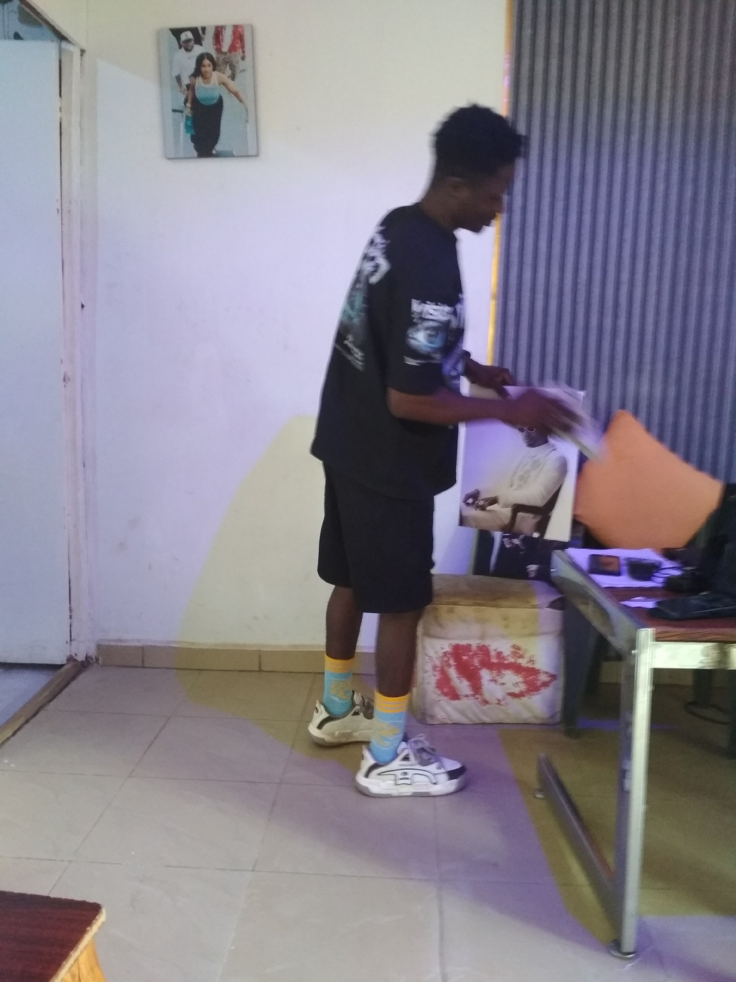 Person in black outfit observed handling object indoors