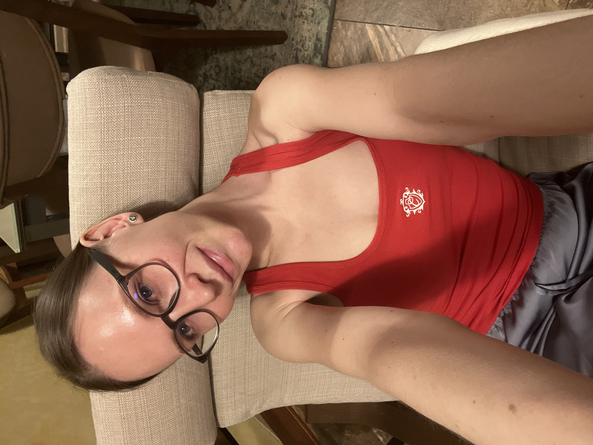 Person in red tank top rests on chair in Khimki