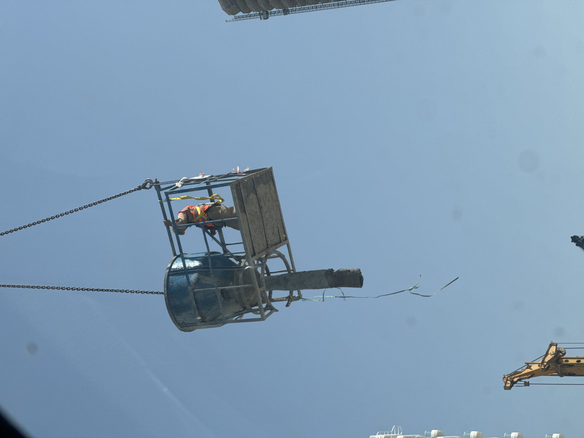 Construction worker operates from suspended concrete bucket in Dubai