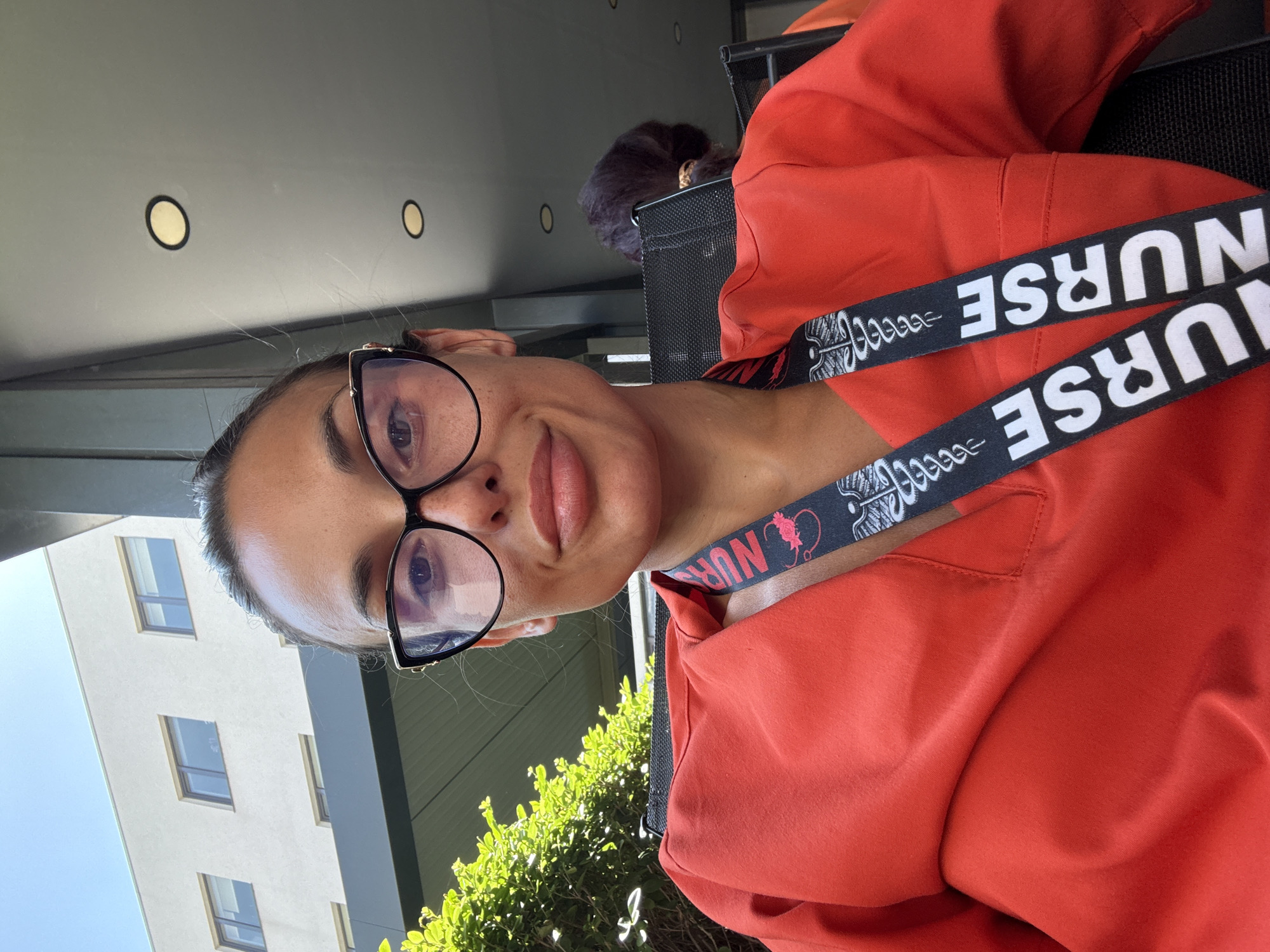 Nurse in red scrubs snaps a selfie in Pleven