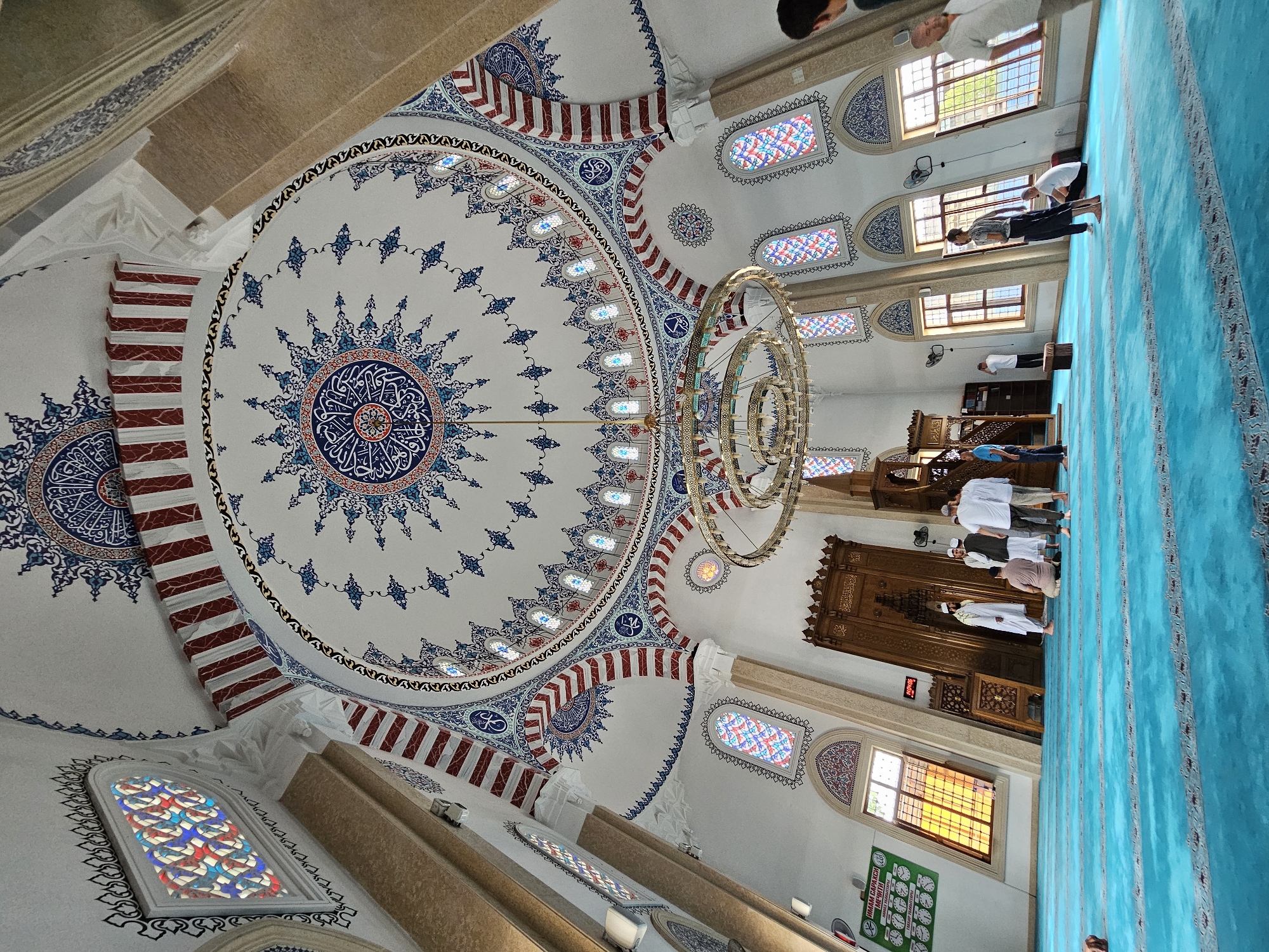 Inside an Özgön mosque: dome details and congregation in prayer