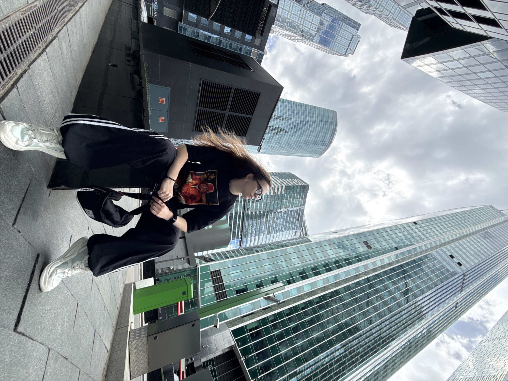 Woman sits on urban ledge in Khimki, Russia