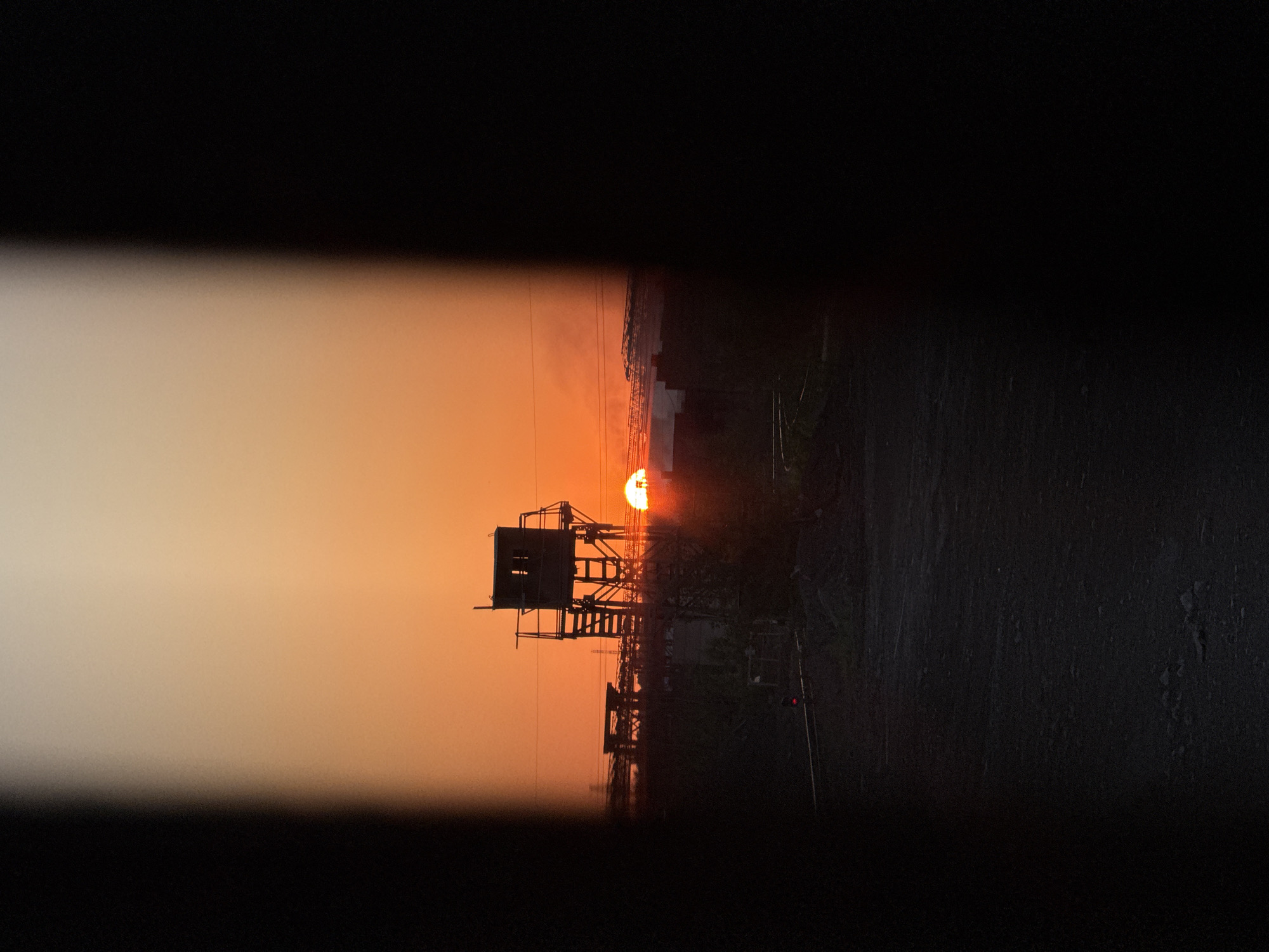 Guard tower cuts a stark silhouette against Magnitogorsk sunset
