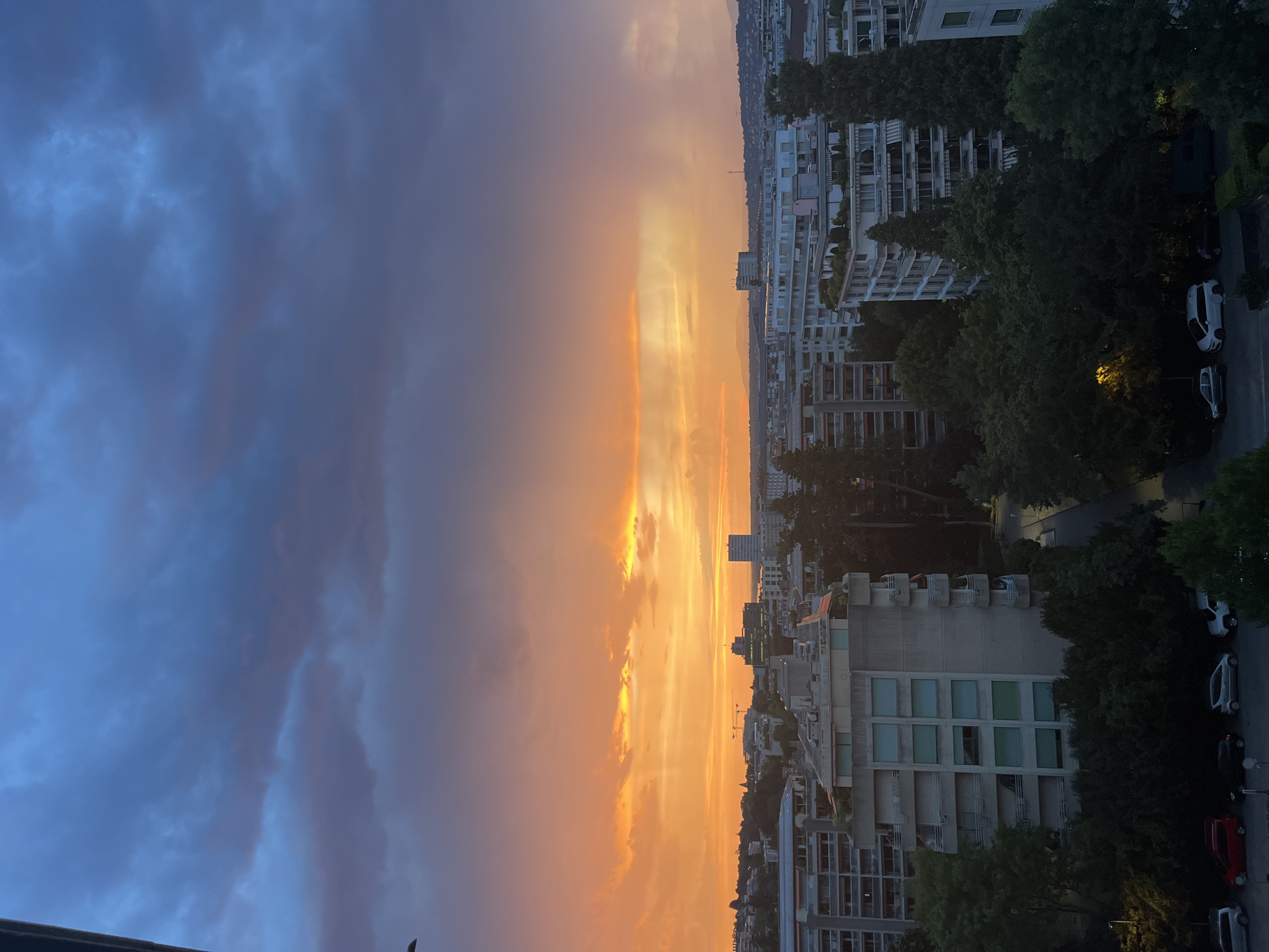 Geneva skyline glows under a dramatic dusk sky