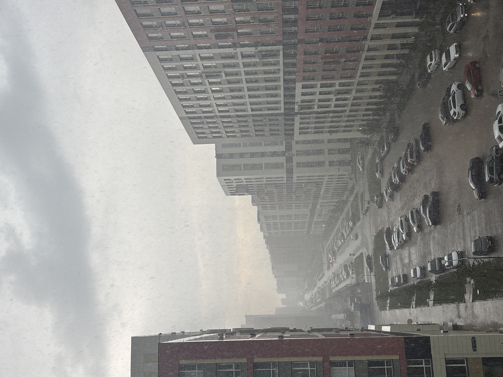 Summer rainstorm rolls through Astana apartment district