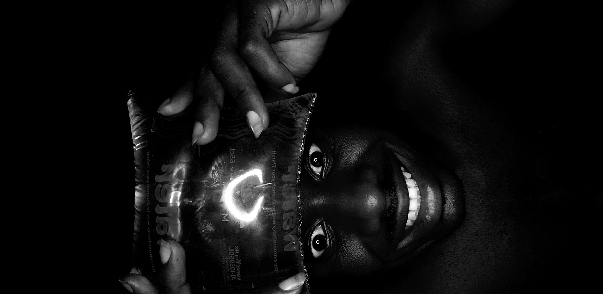 Person photographed with water pouch, package in Narayi