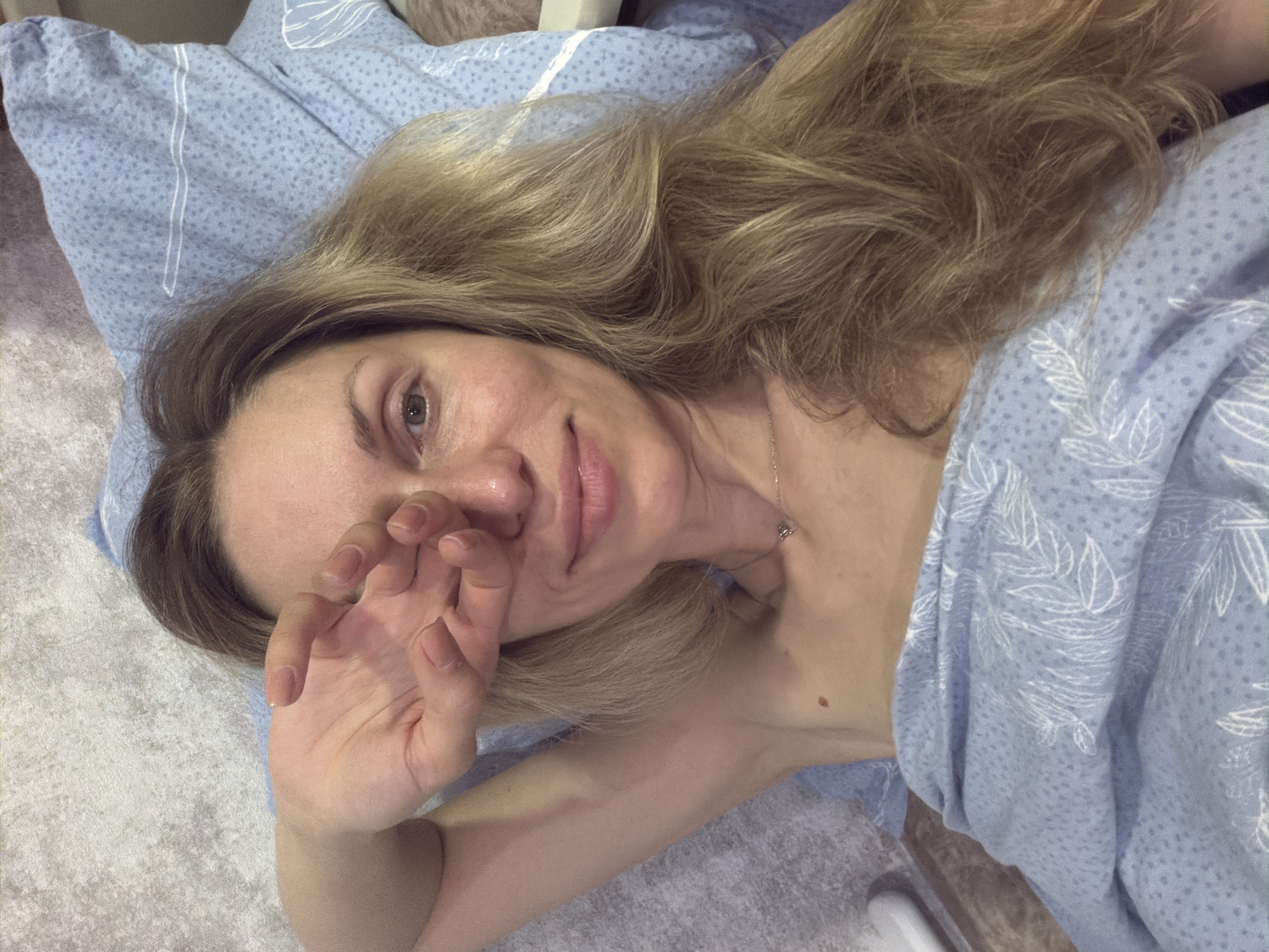 Resting on a blue pillow, hand over eye, indoors in Sochi