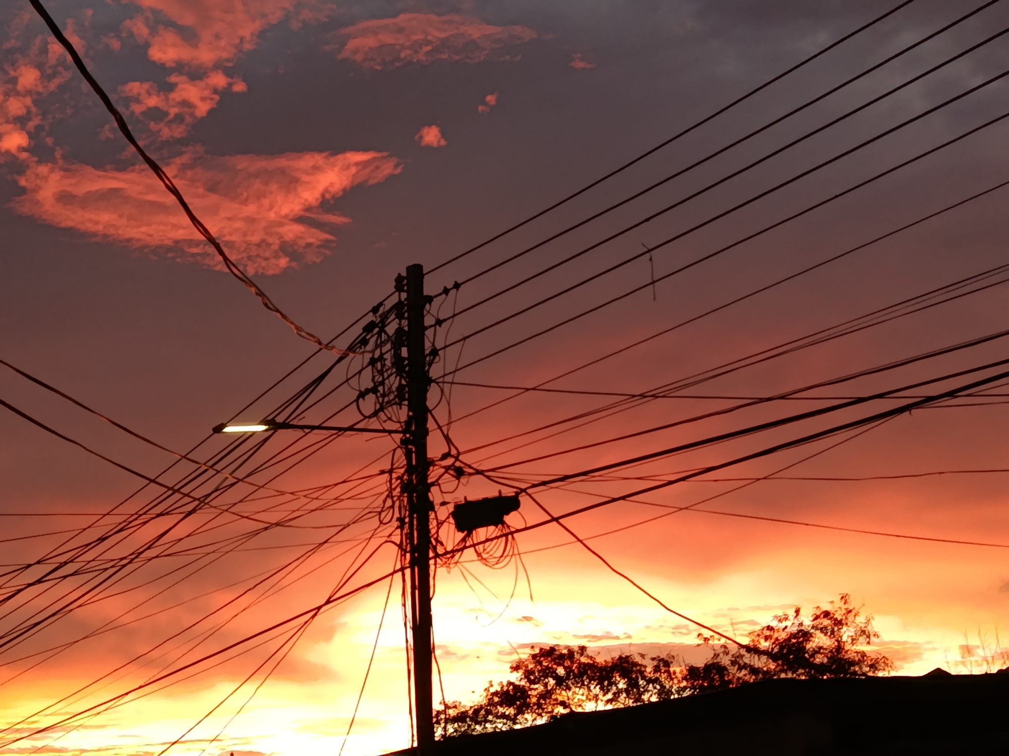 Sunset over Juan Griego streets, power lines and all