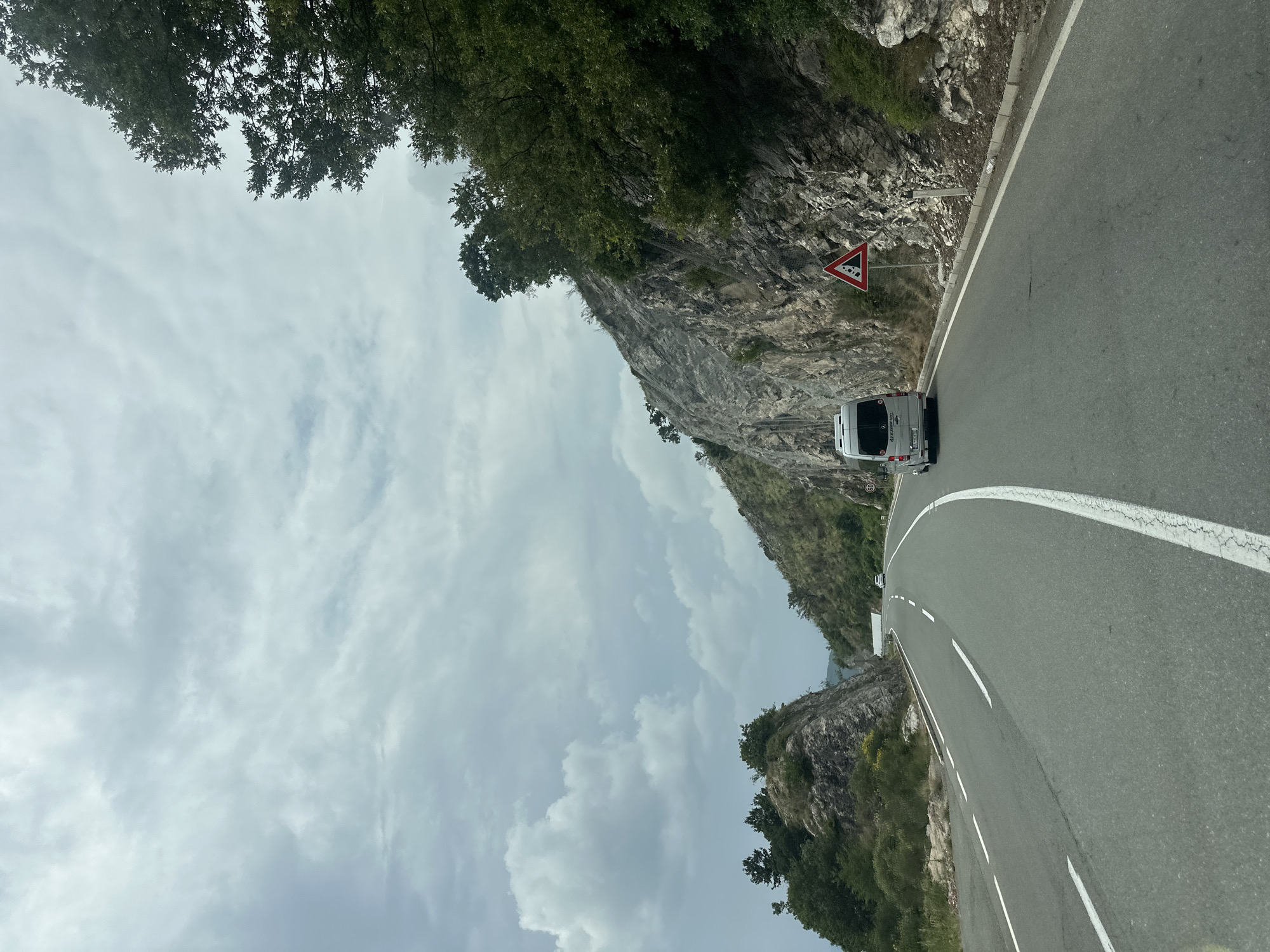 White camper van travels mountain road in Montenegro