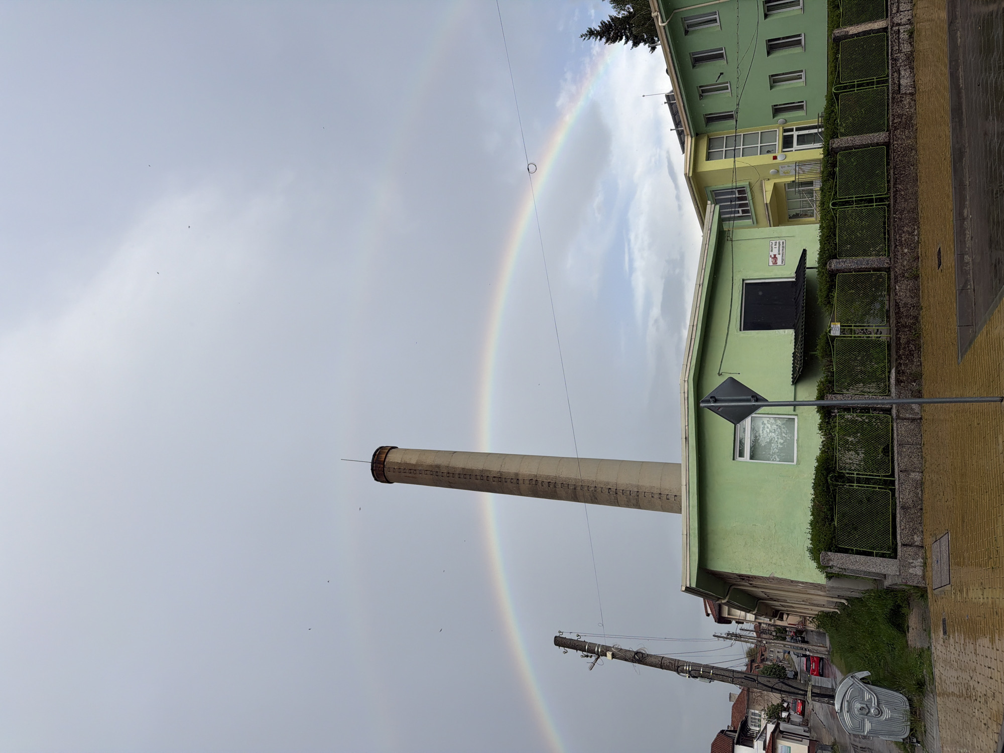 Rainbow appears over industrial smokestack in Panagyurishte, Bulgaria
