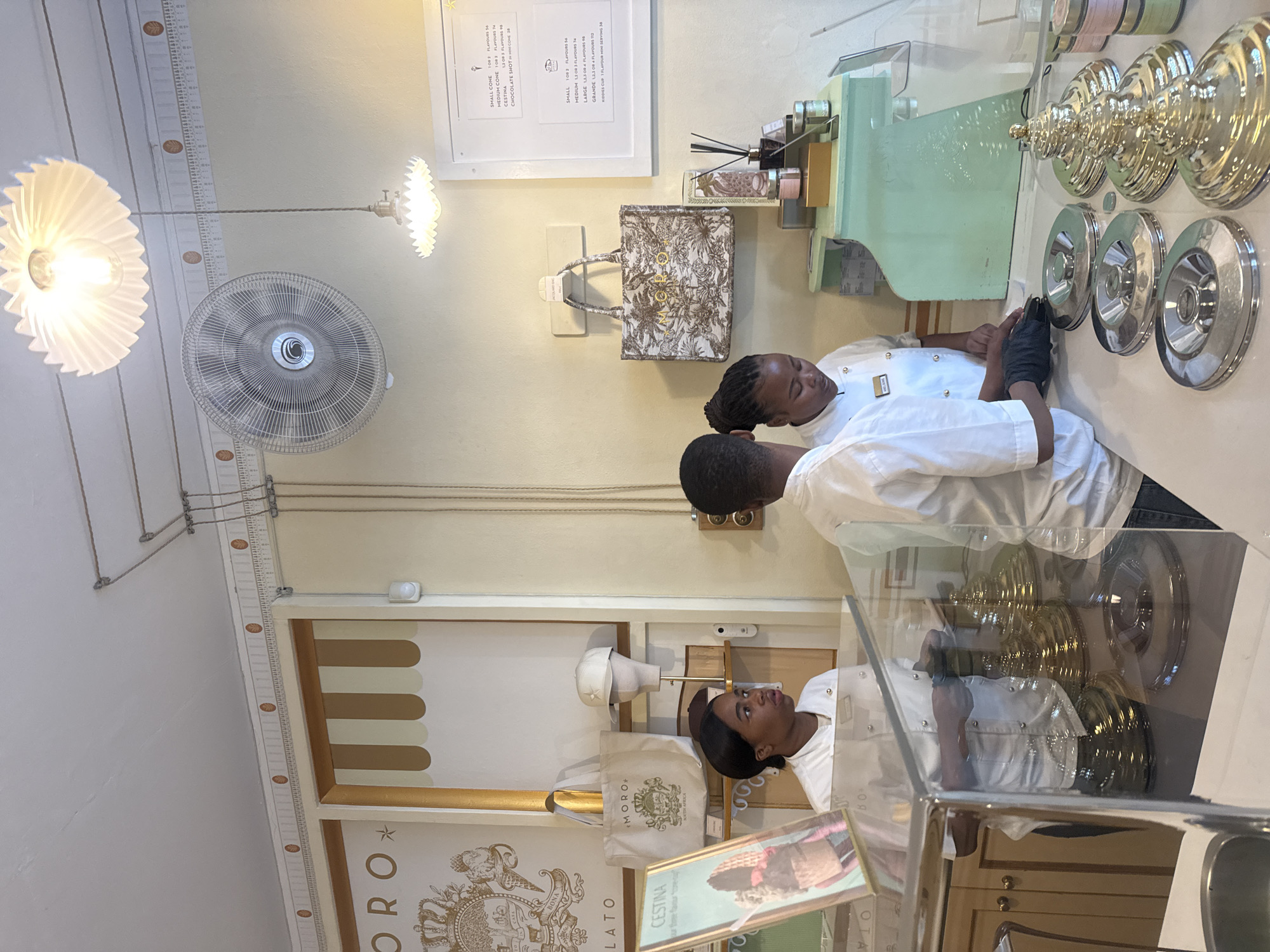 Gelato shop employee serves customers in Cape Town