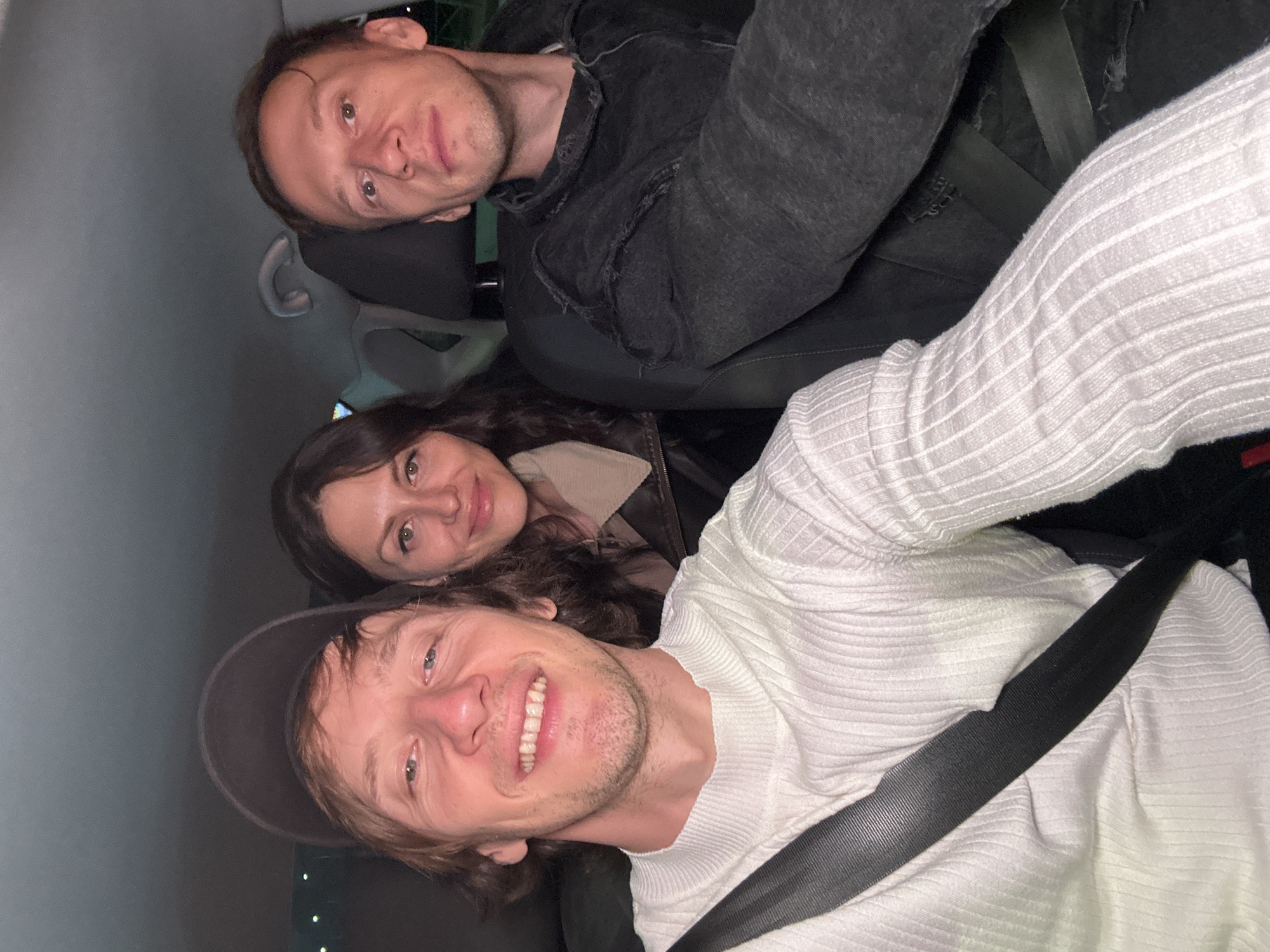 Three people inside a car at night in Saint Petersburg