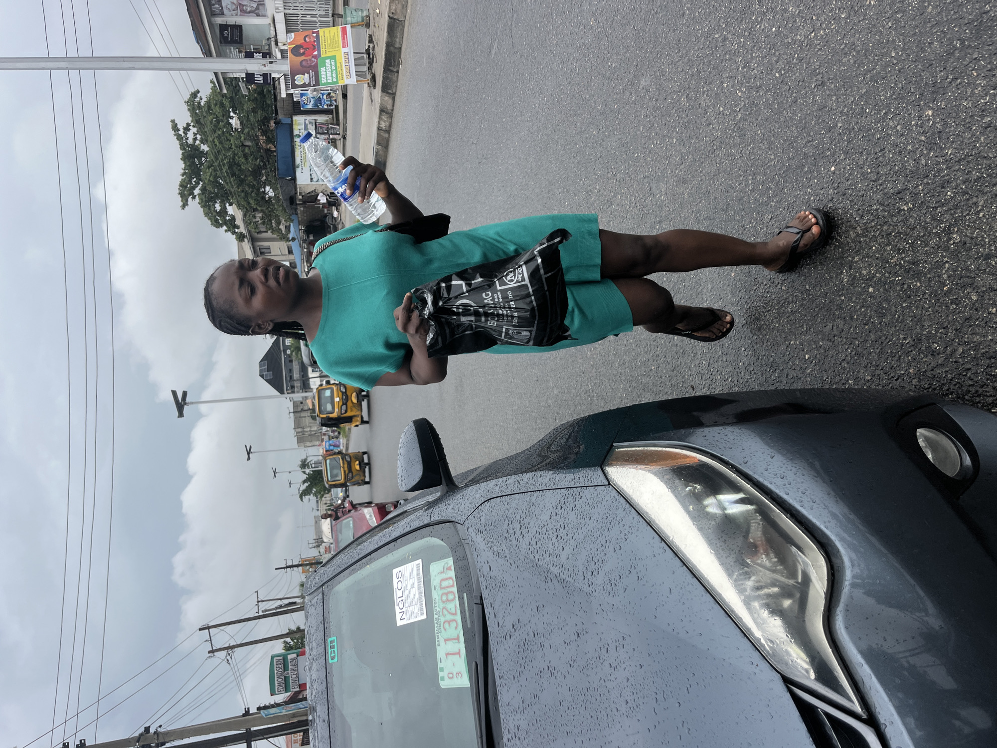 Wet afternoon street life and commerce in Ado, Nigeria