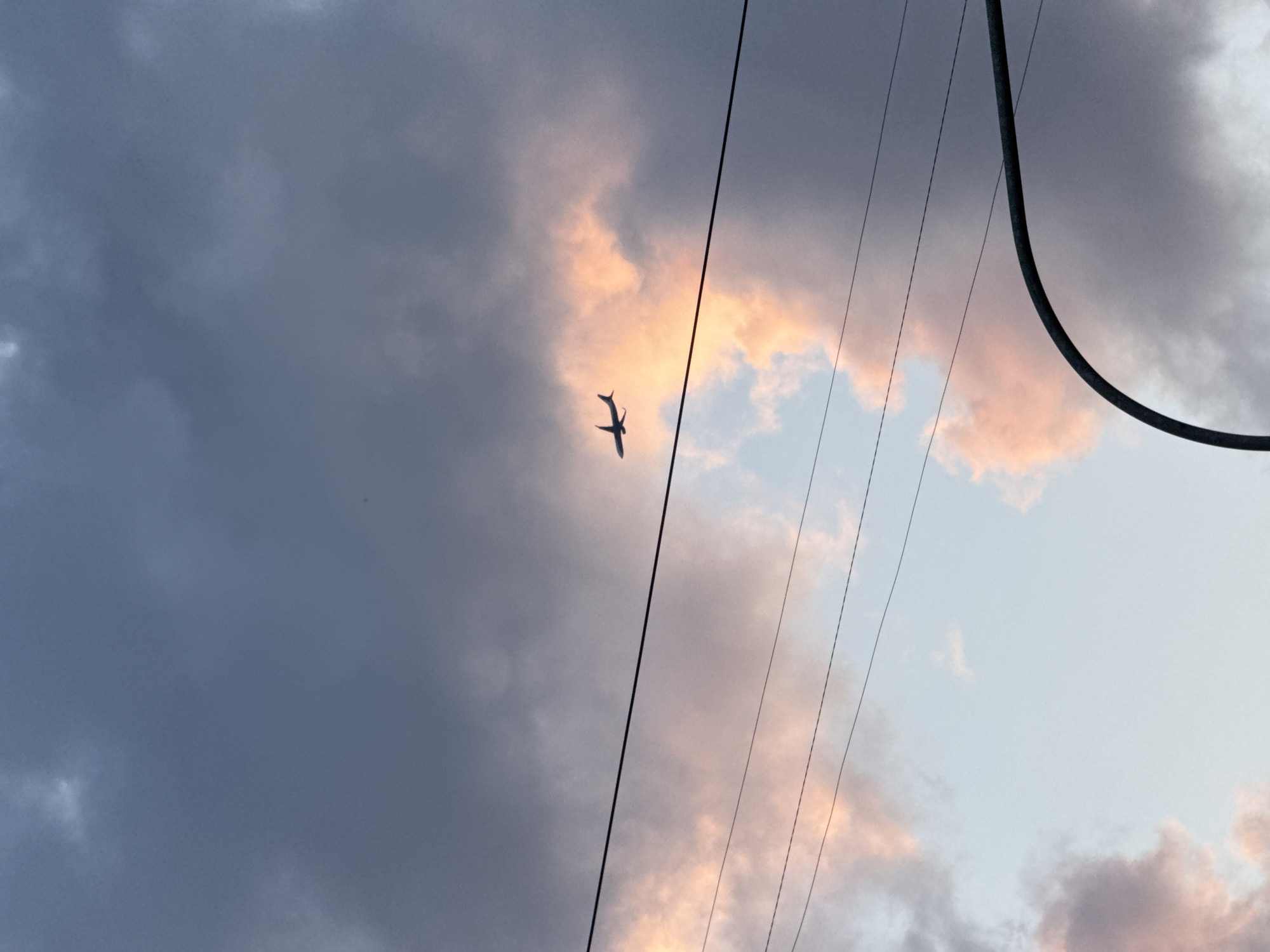 Saint Petersburg at dusk, planes and pink clouds overhead