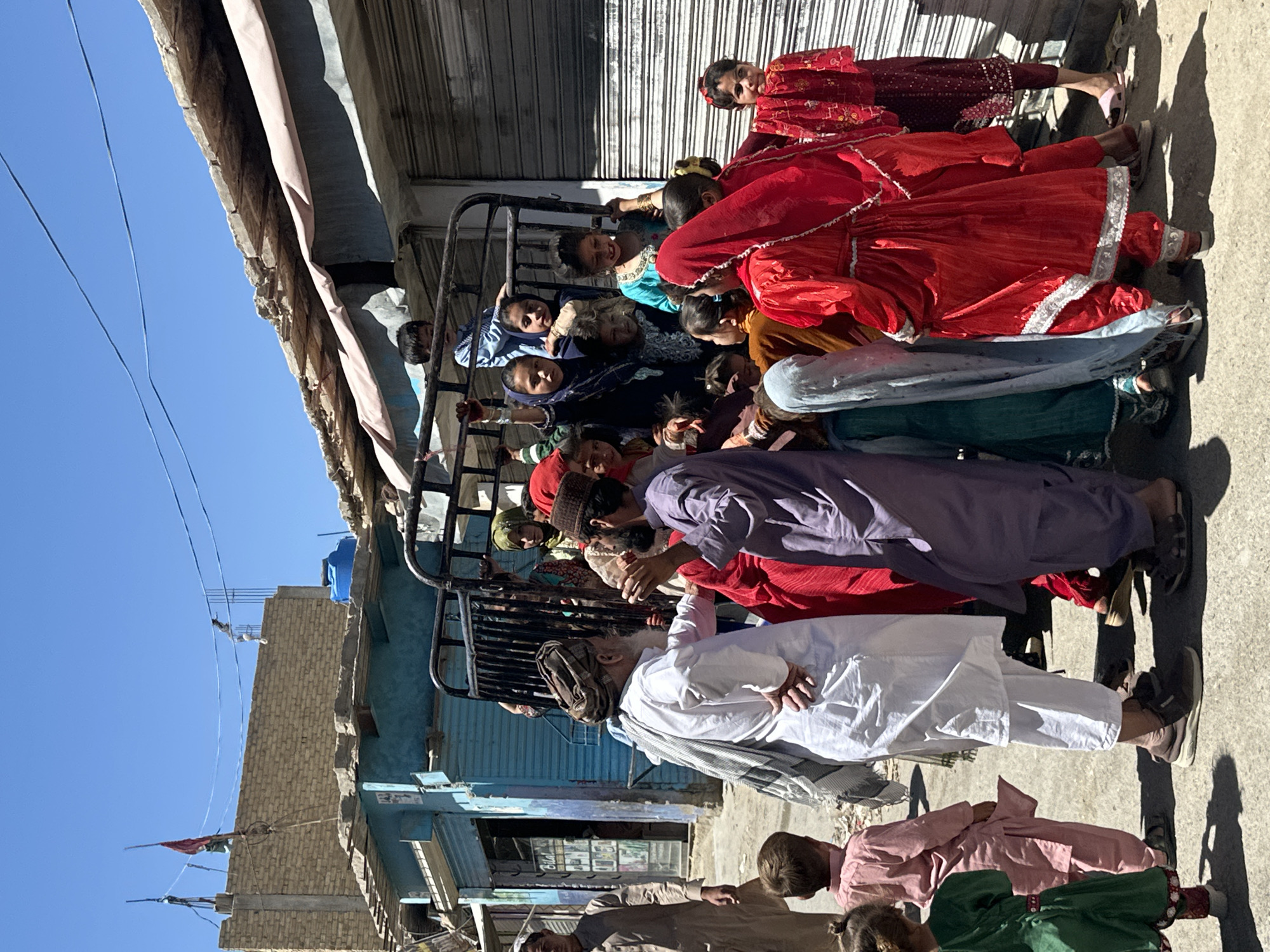 Children gather around makeshift Ferris wheel in Quetta marketplace