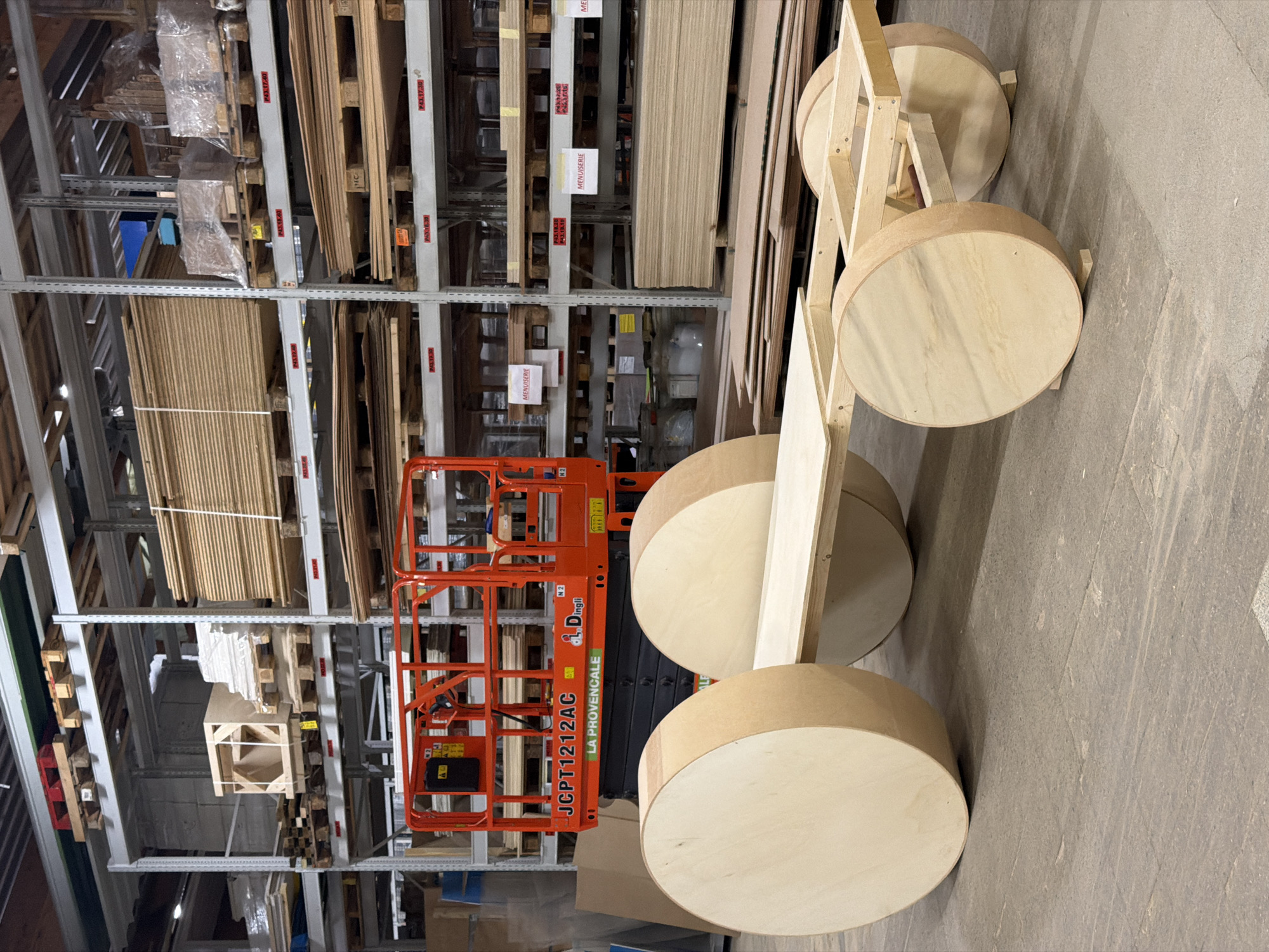 Wooden vehicle prototype and tractor blueprints in a Luxembourg workshop