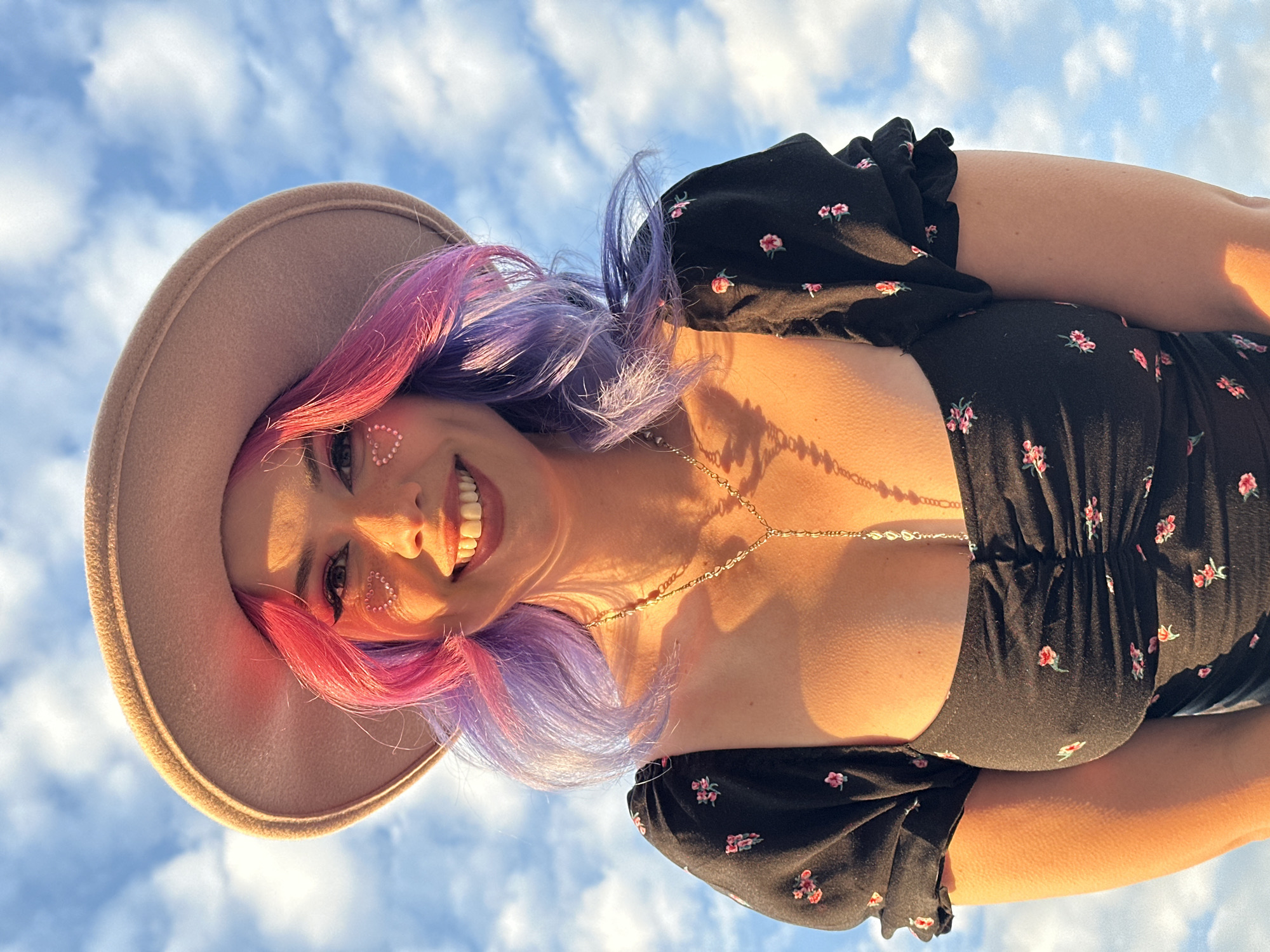 Woman photographed smiling outdoors in Zagreb during golden hour