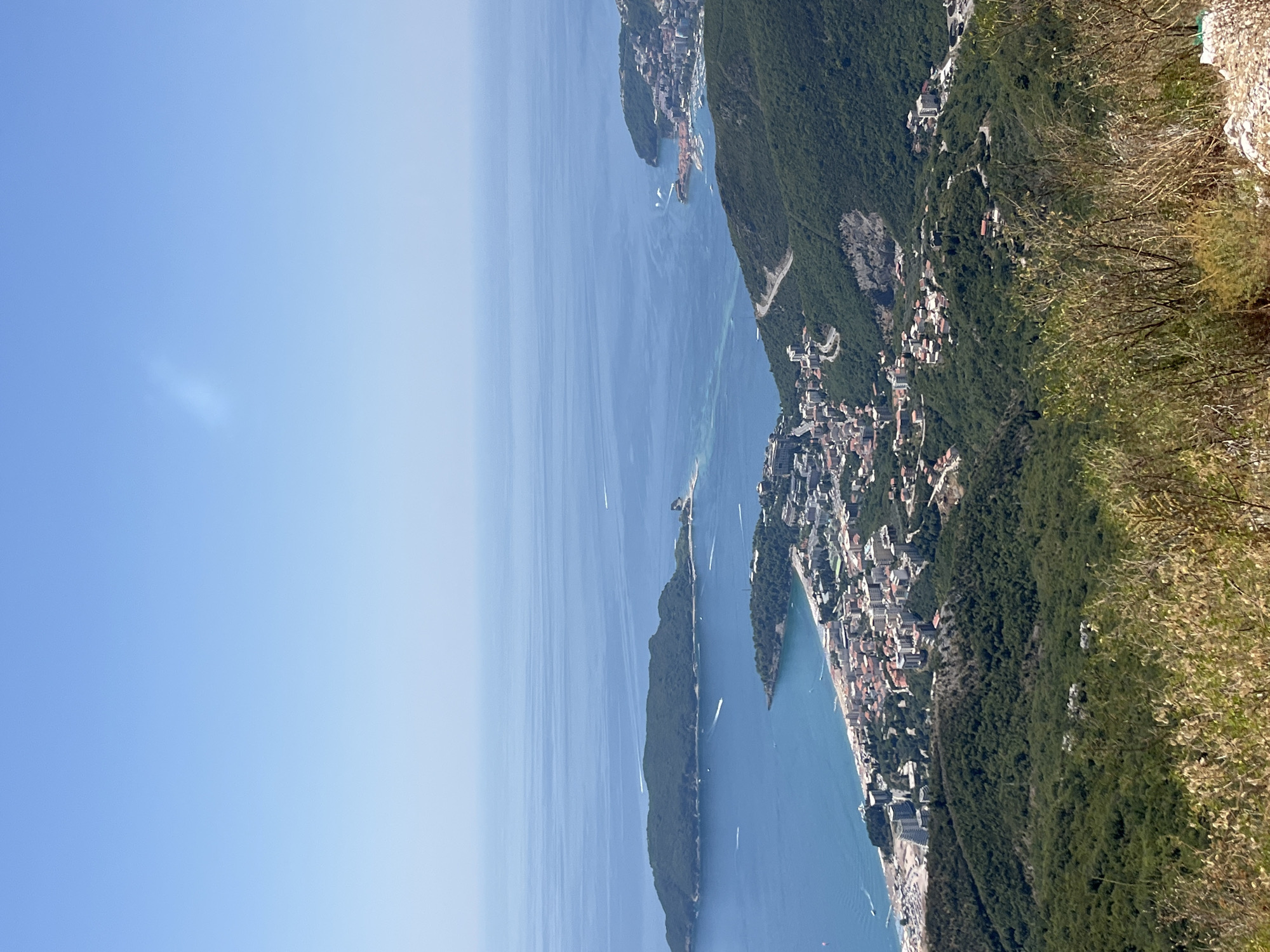 Paragliding over Brajici's Adriatic coastline on a clear morning