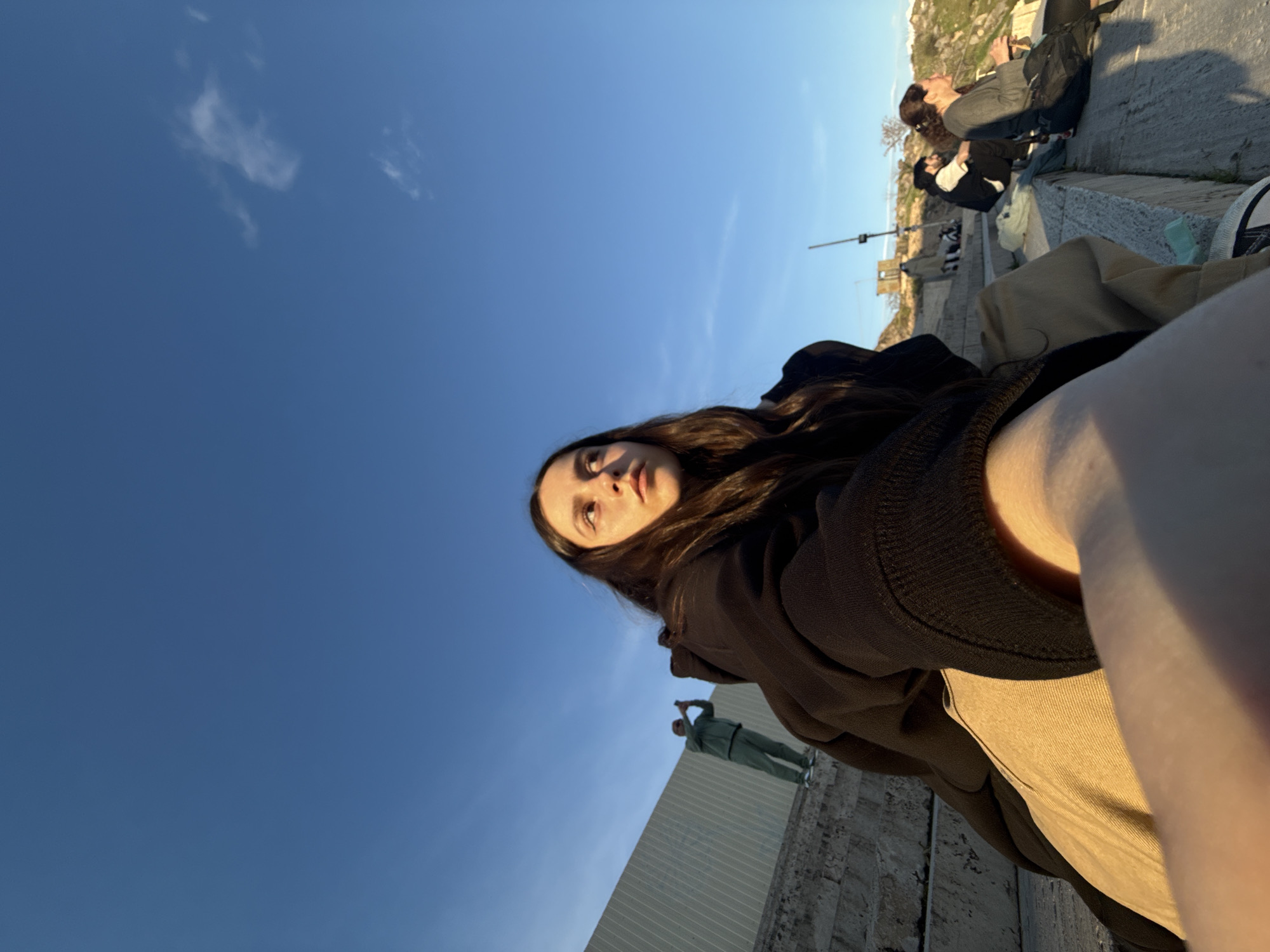 Tourist documents golden hour city views from Yerevan overlook