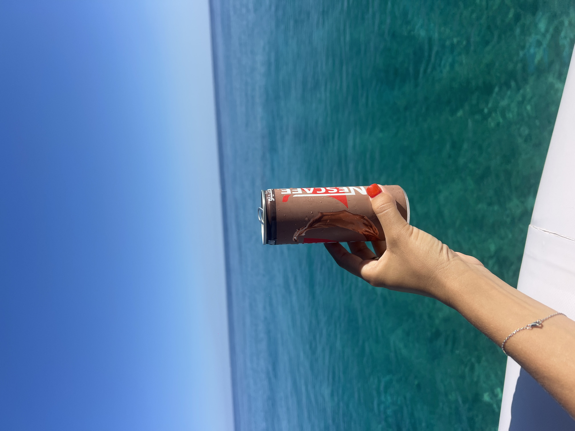 Nescafé in hand, drifting over clear turquoise water off Egypt