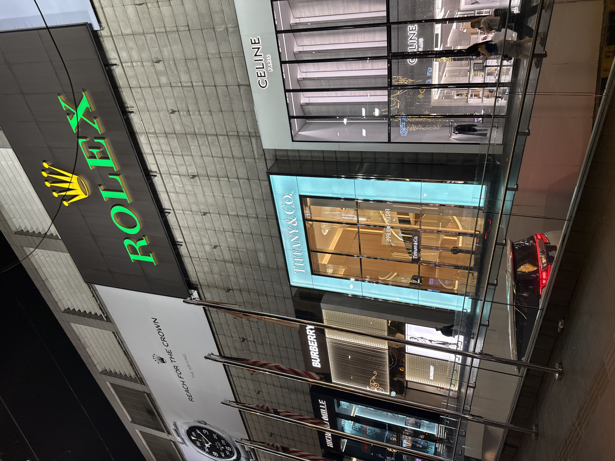 Nighttime luxury shopping district activity documented in Kuala Lumpur