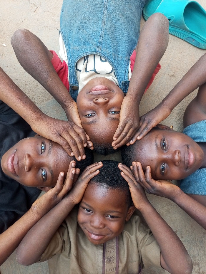Children play with tire in circular formation, Tempure Nigeria