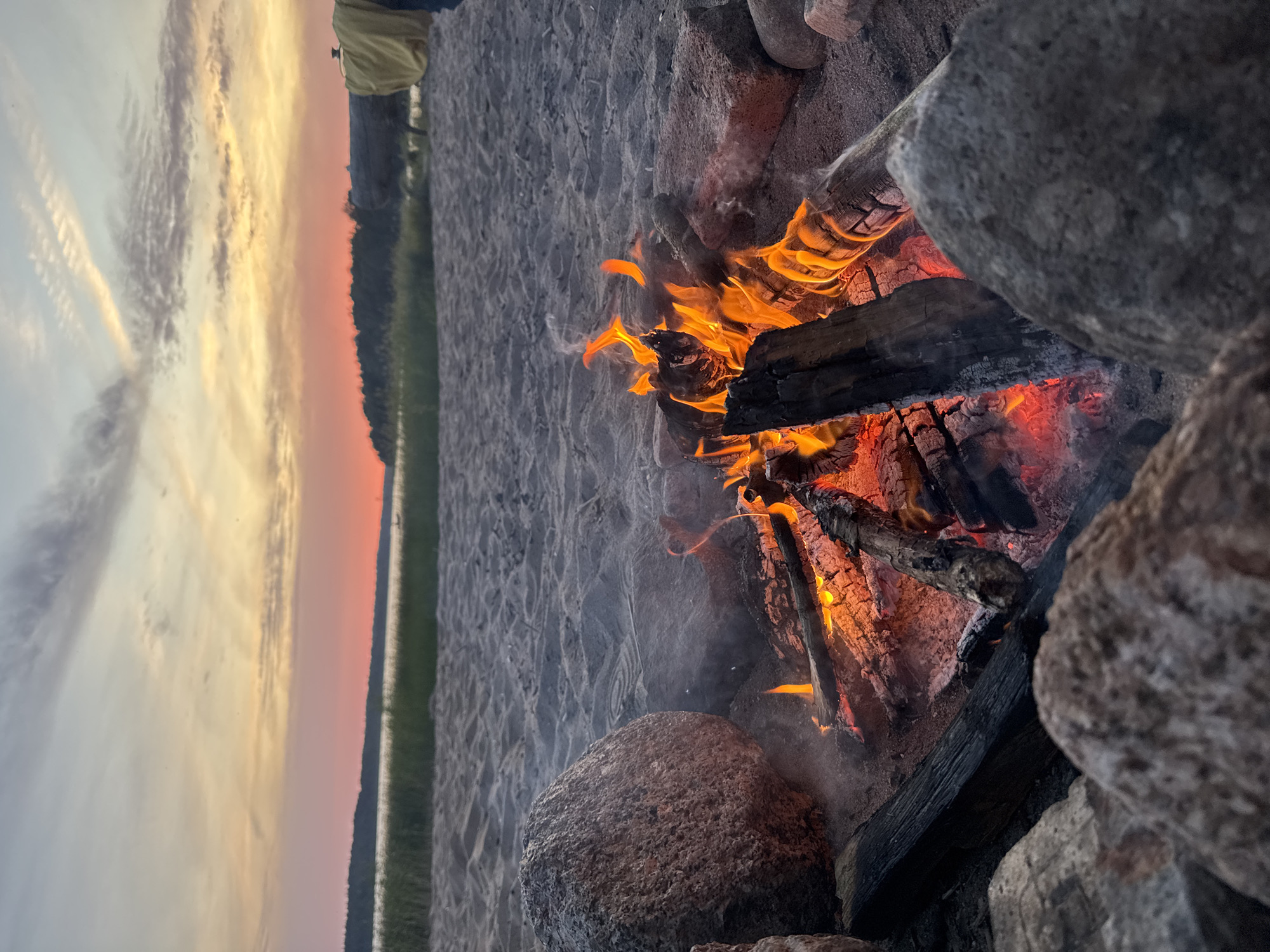 Beach bonfire at sunset on the Russian shore