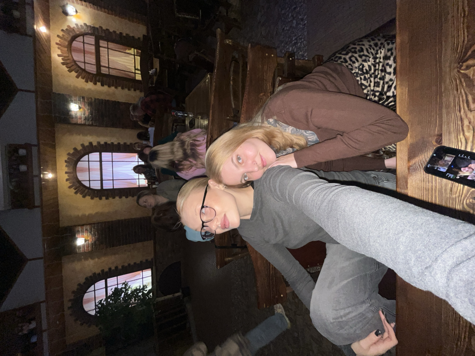Two women document cafe visit with selfies in Chaikovsky