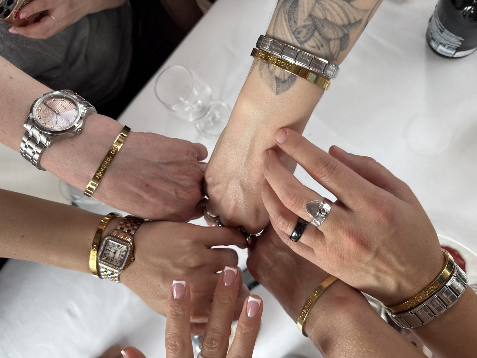 Women gather around Moscow table in celebratory gesture