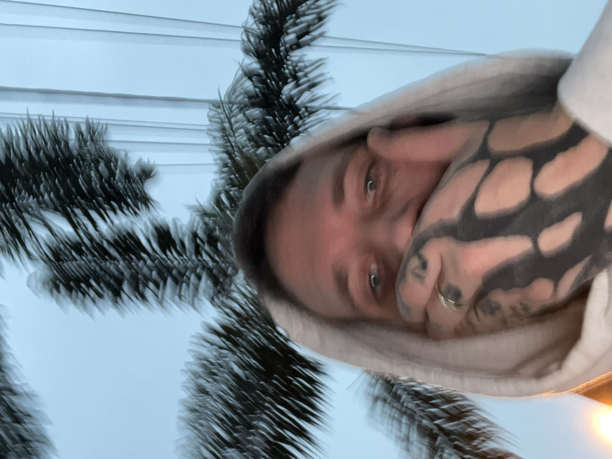 Tattooed individual takes selfie outdoors in Cordoba, Argentina
