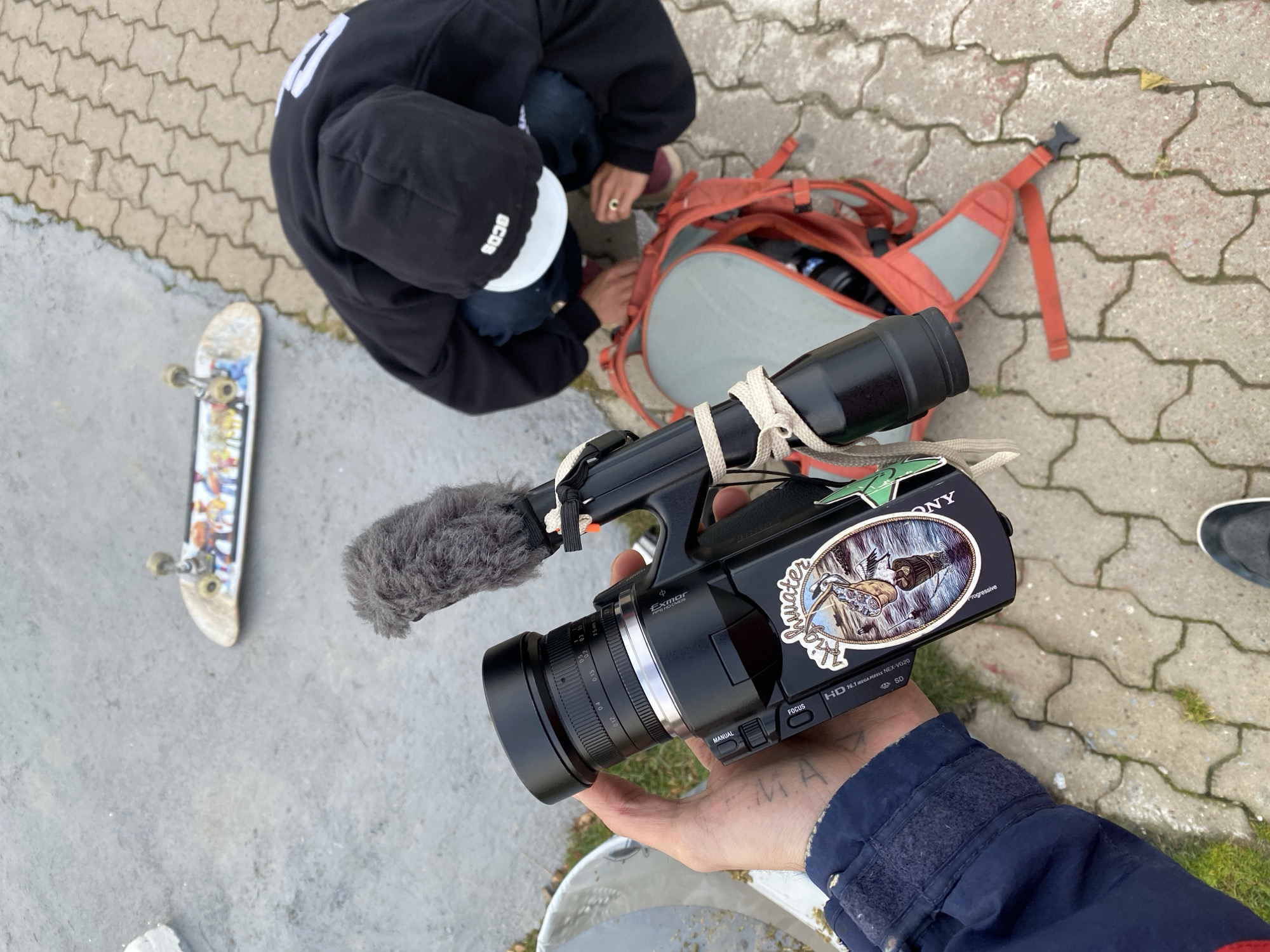 Person adjusts backpack contents on Ushuaia street