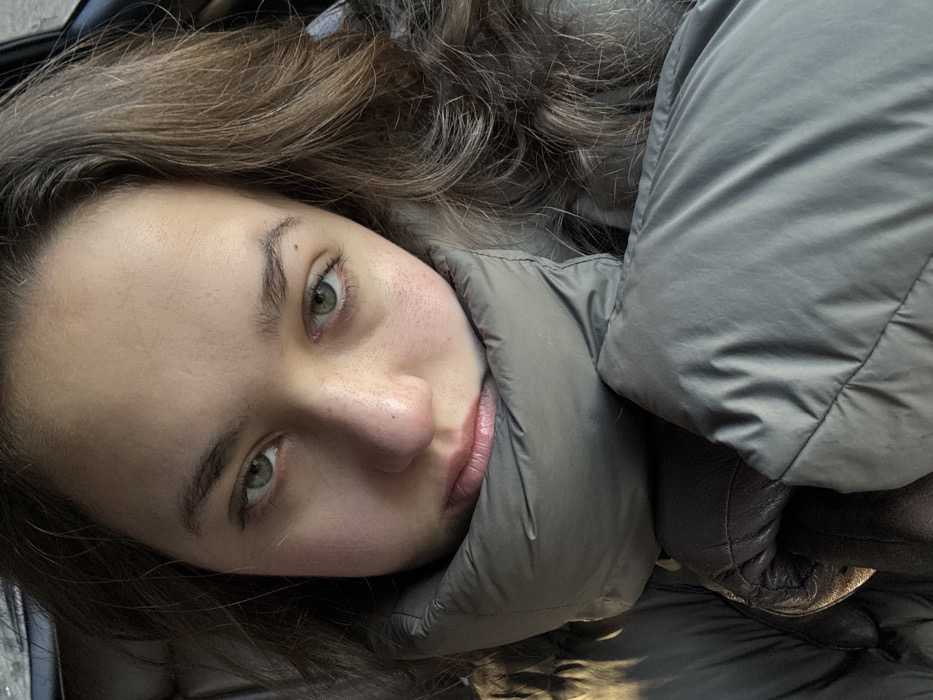 Woman photographed in car with smartphone, Sofia morning