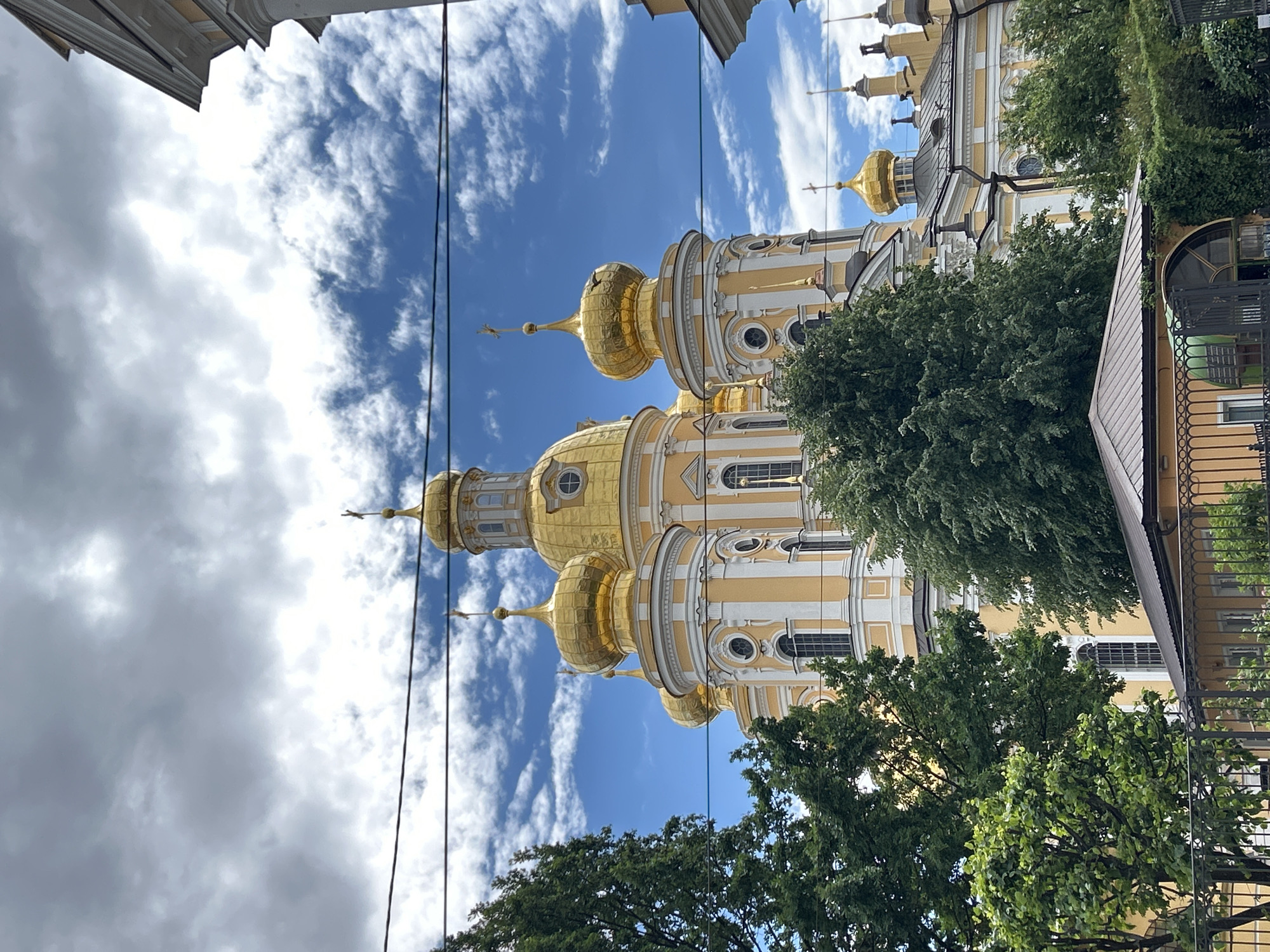 Golden domes and canal boats along a Russian riverfront