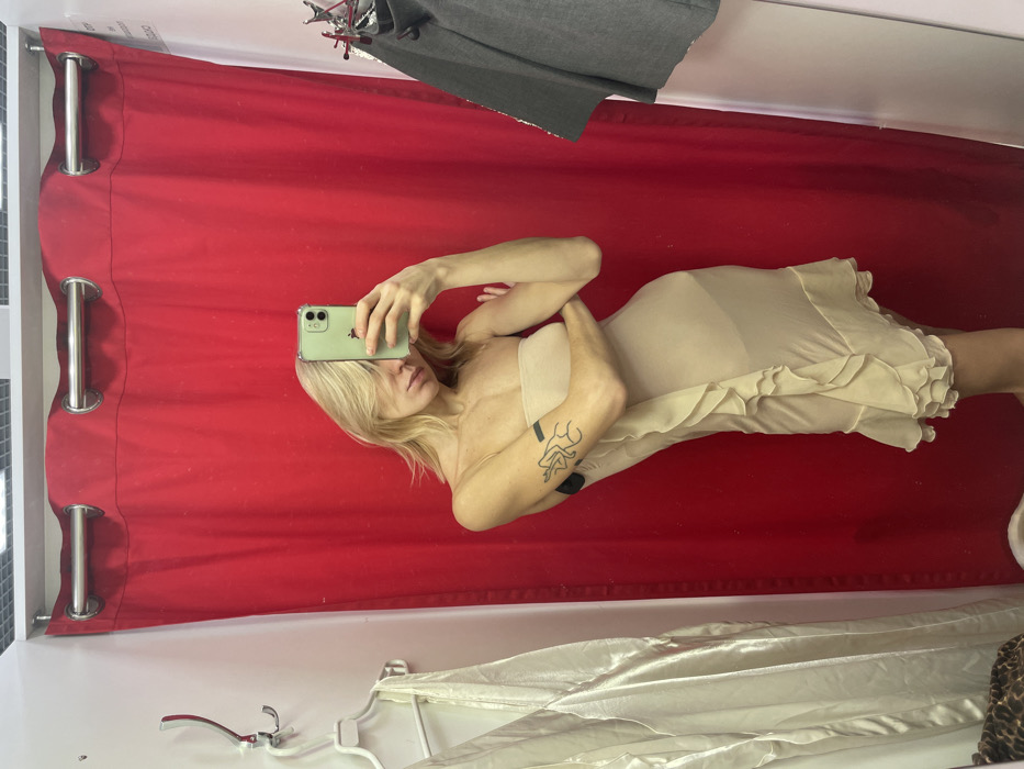 Person tries on dresses in Moscow fitting room