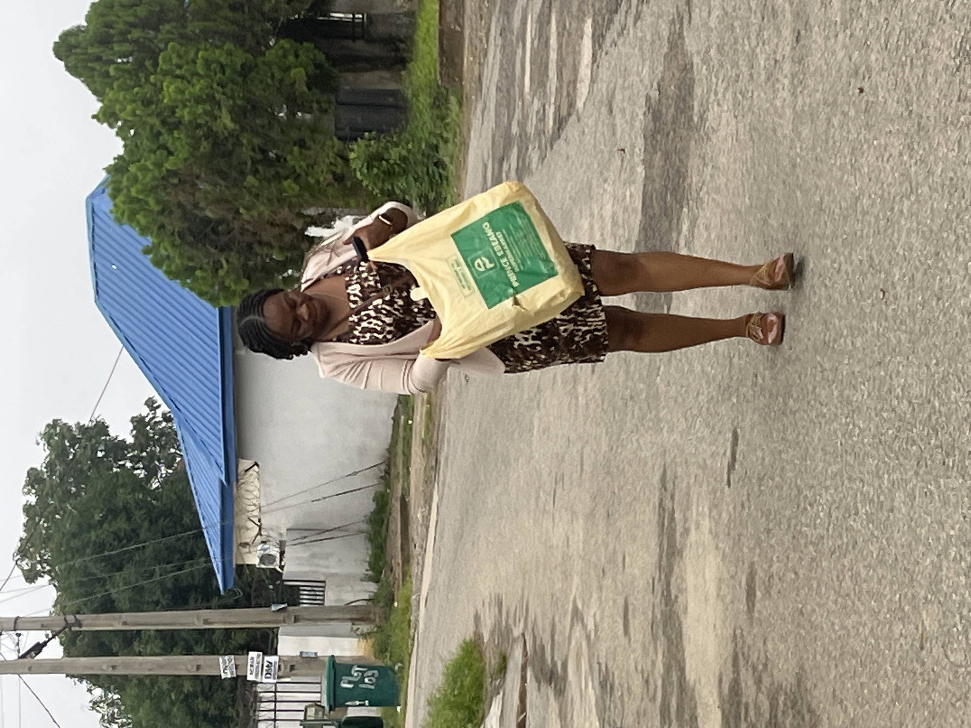 Morning foot traffic on Abuja streets, with a car drawing attention