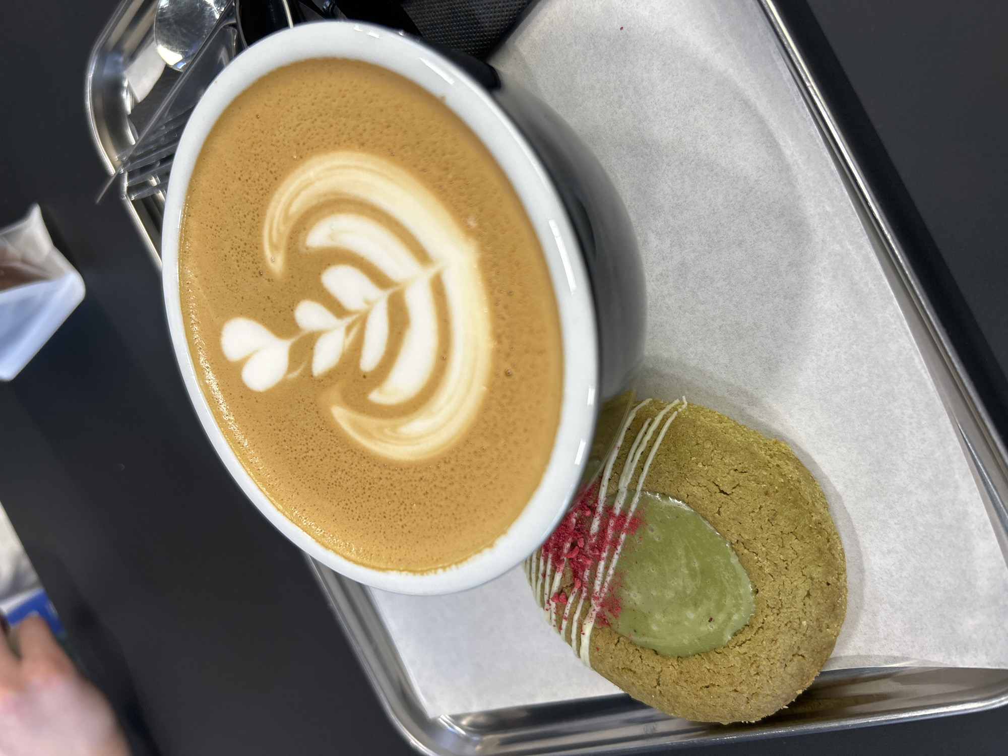 Coffee and decorated cookie served at Izhevsk cafe