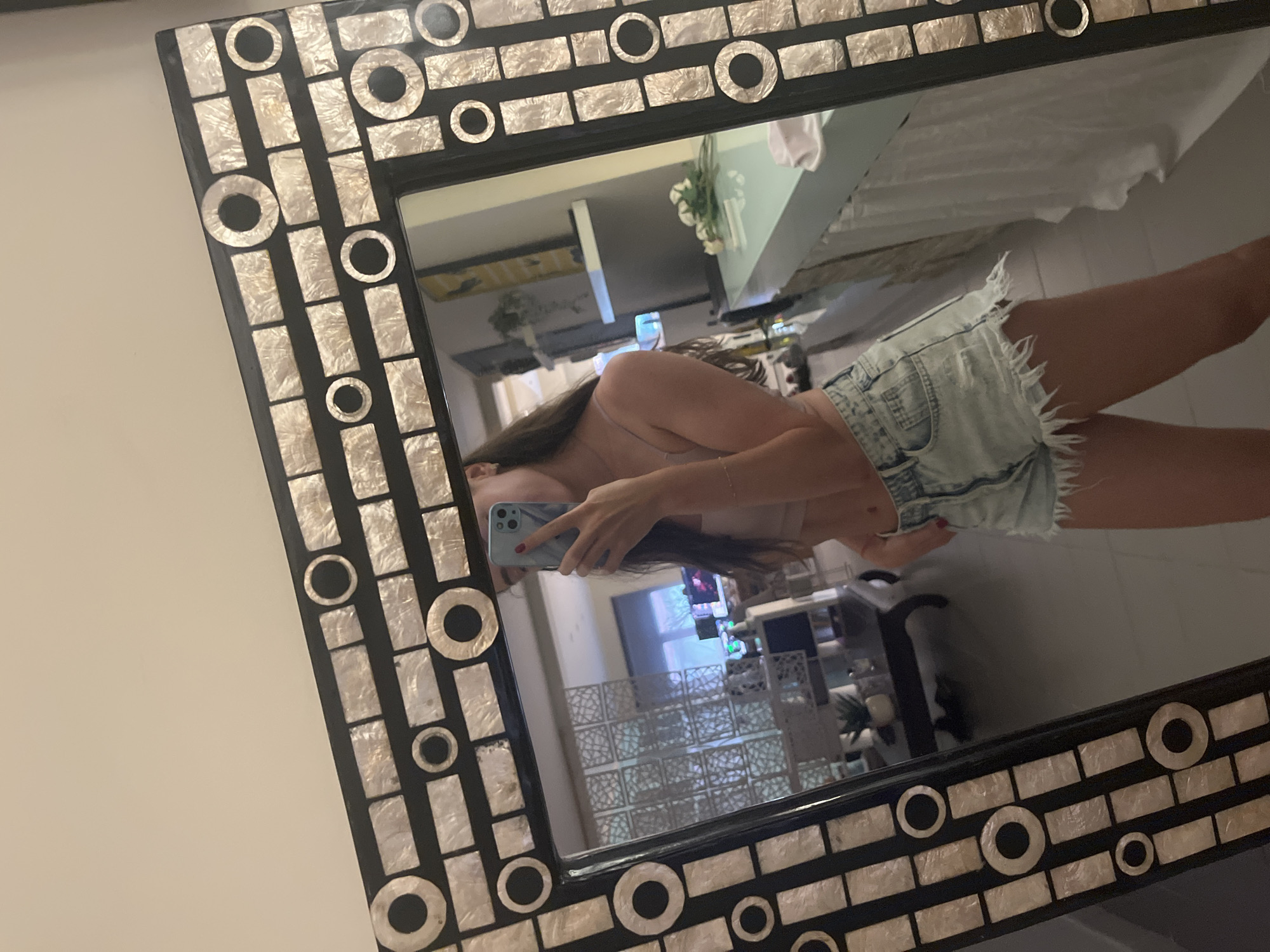 Person takes mirror selfie indoors in Alicante, Spain