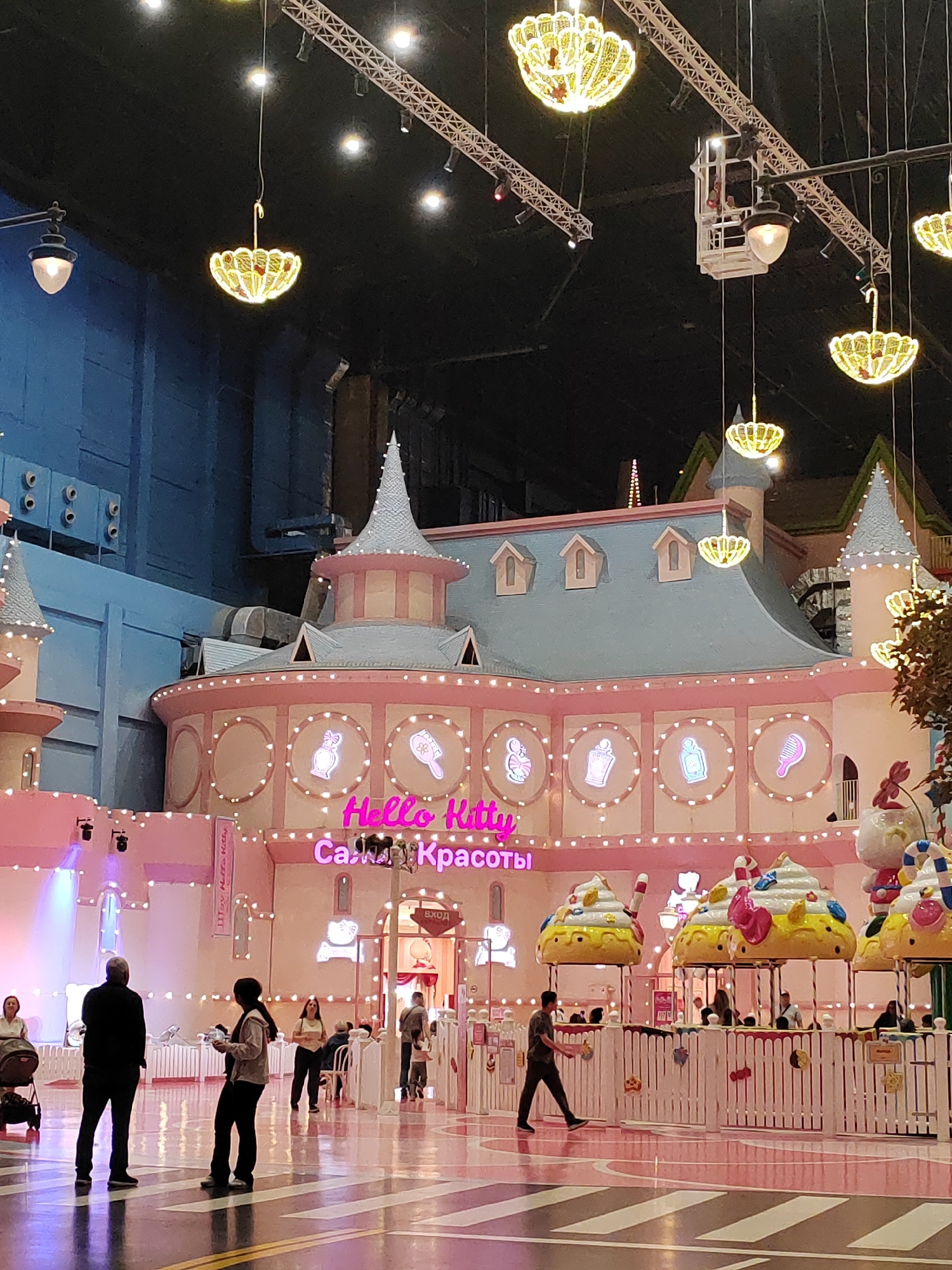 Inside a large indoor theme park with multiple fantasy zones