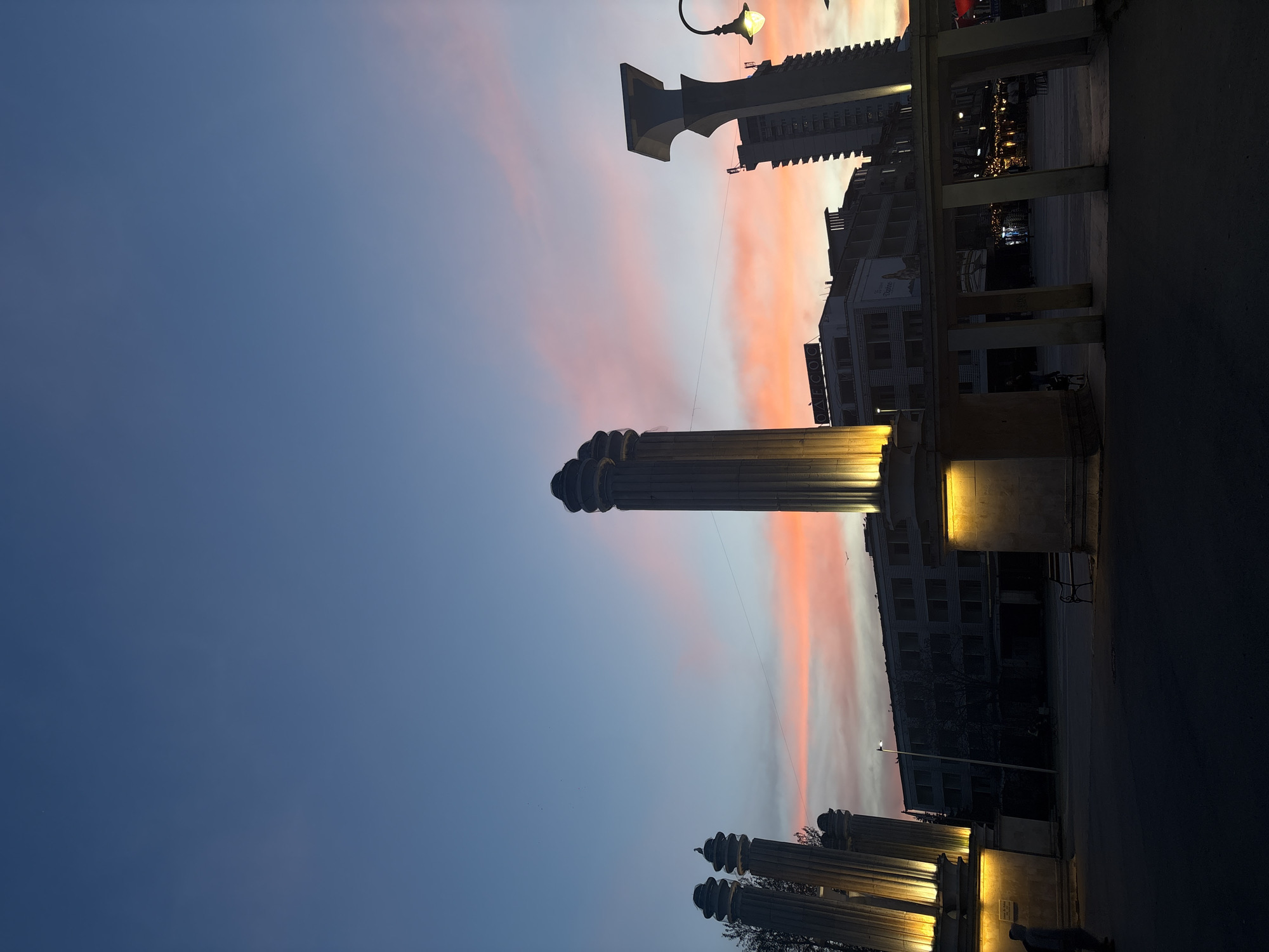 Evening sky photographed over illuminated monuments in Varna, Bulgaria