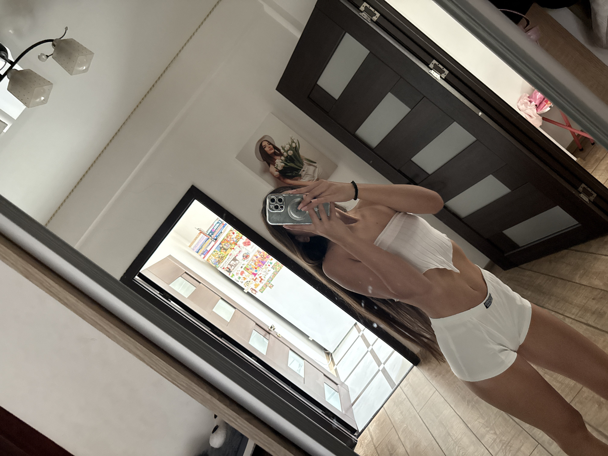 Mirror selfie session in a Chișinău bedroom, white outfit