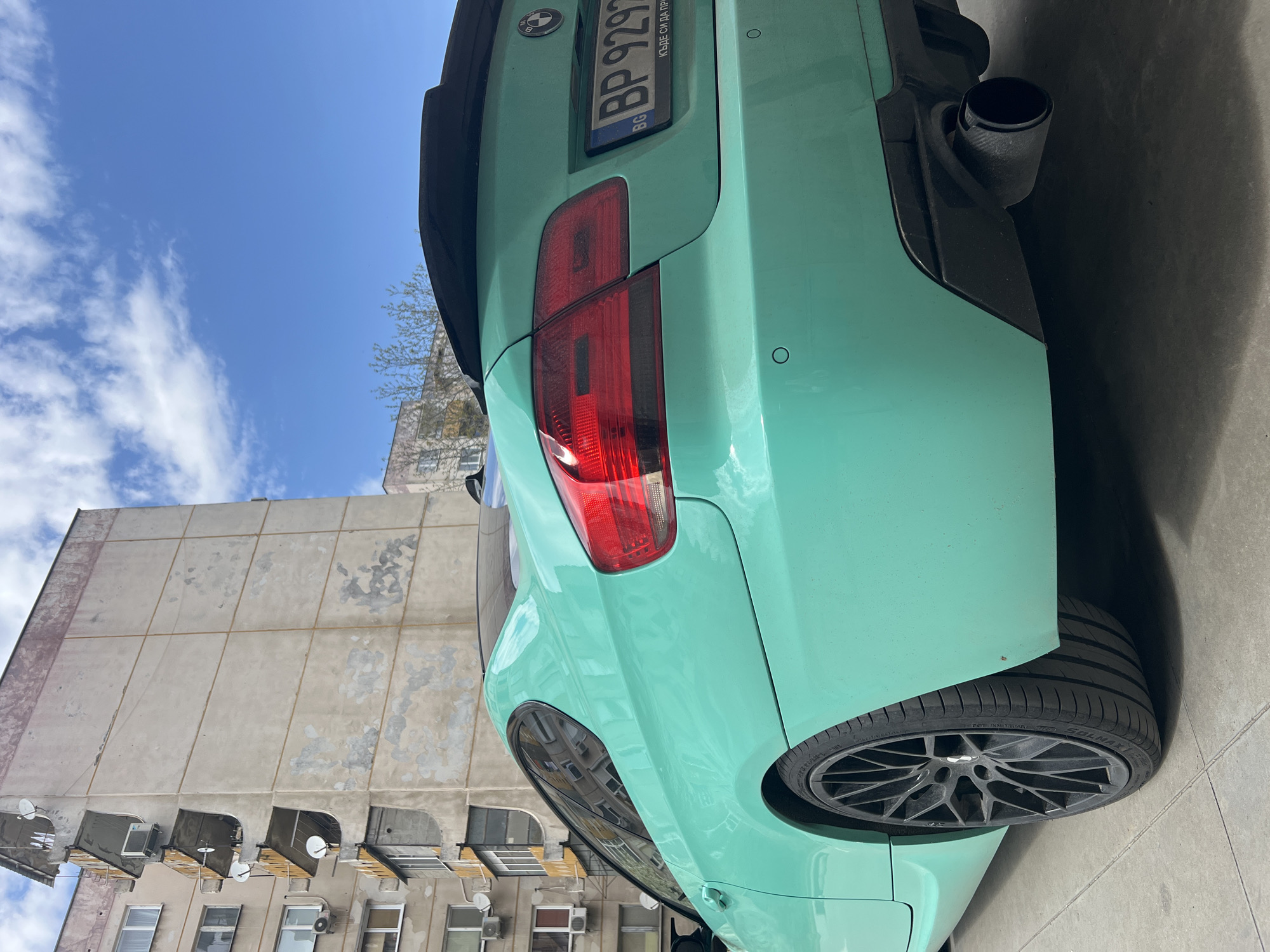 Mint green BMW, elevator selfie captured in Plovdiv street scenes