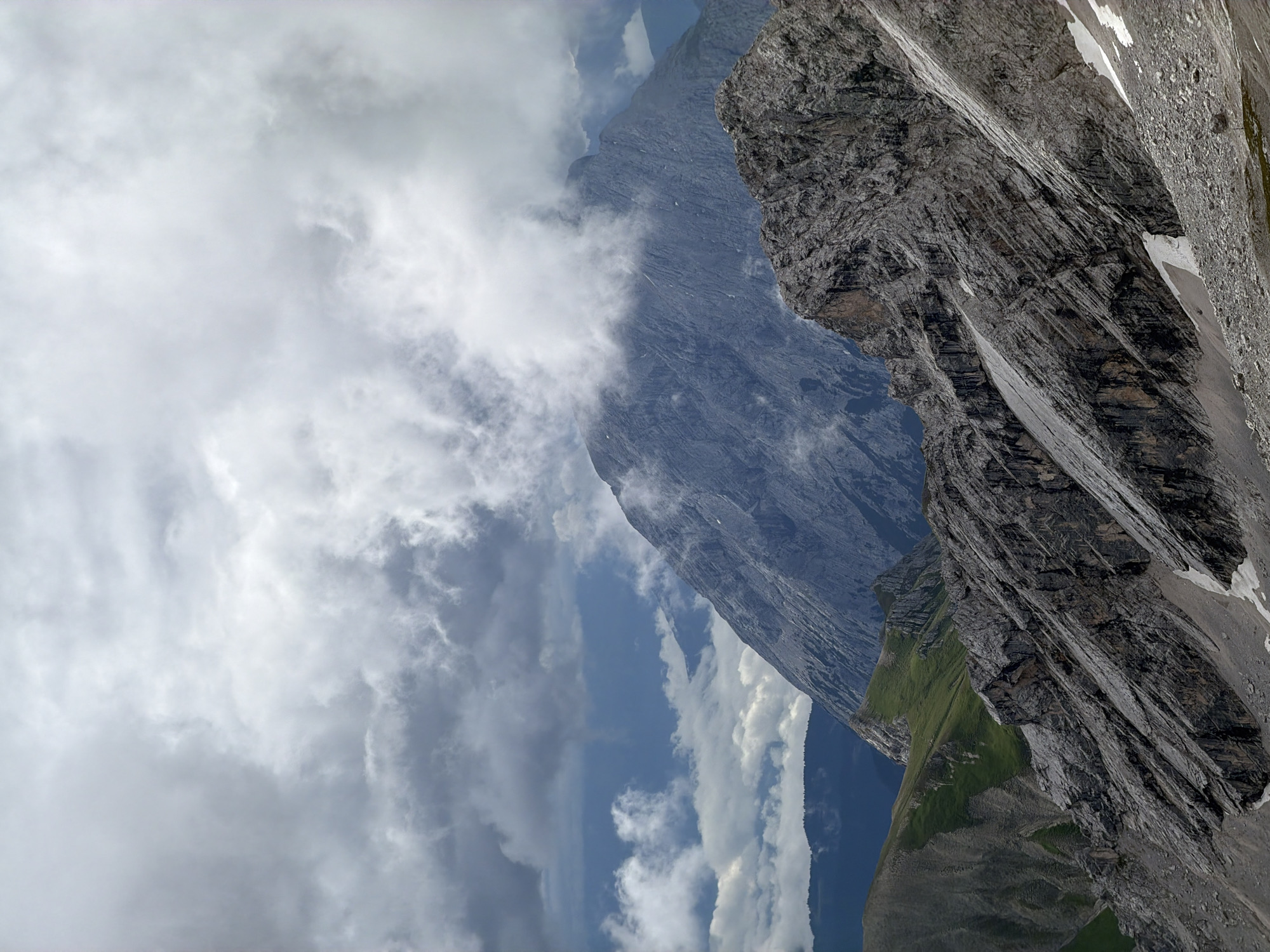 Close-up aerial views of rocky Zugspitze peaks under cloudy skies