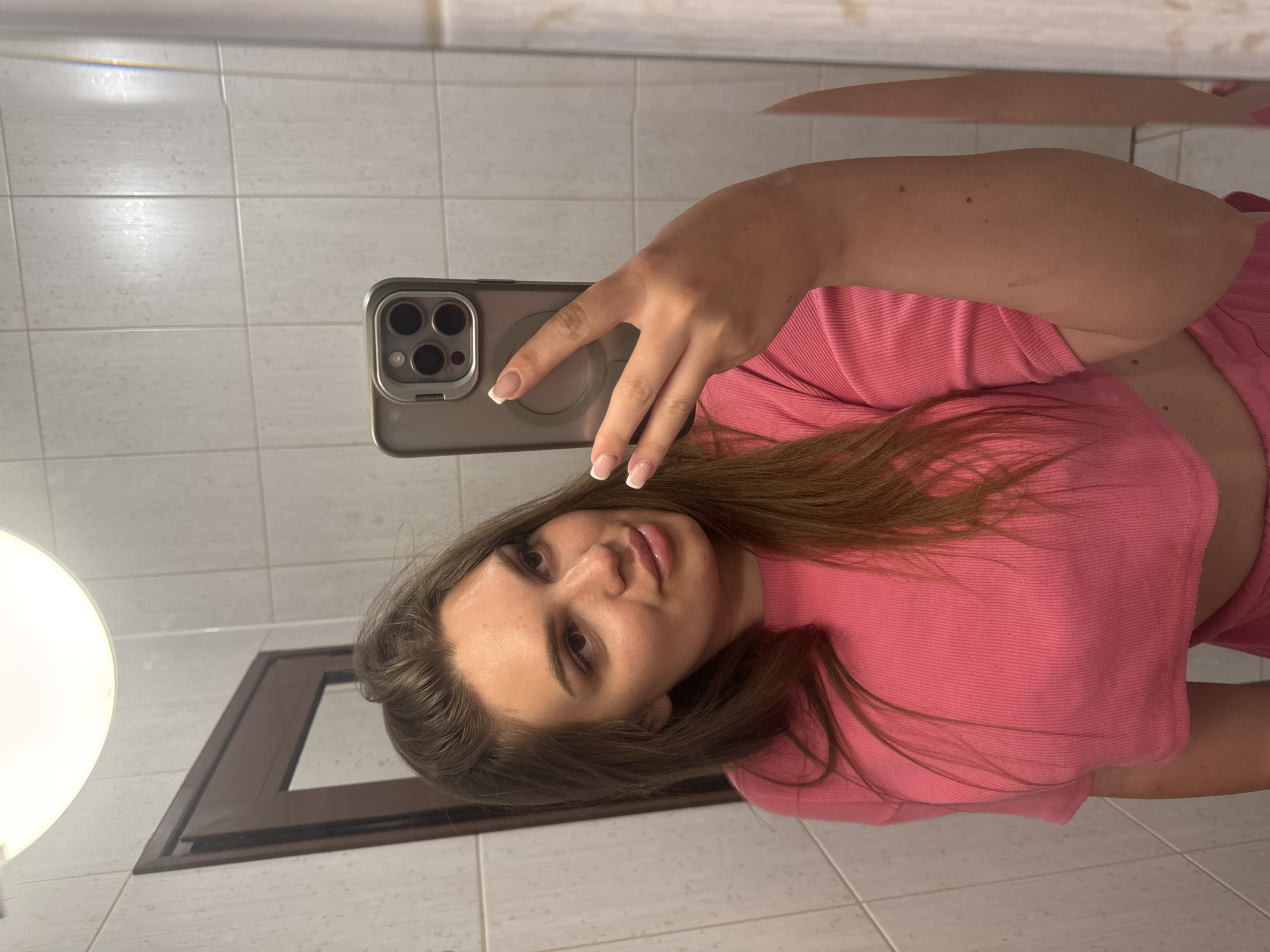 Mirror selfies in a Sofia bathroom, pink outfit, July 2026