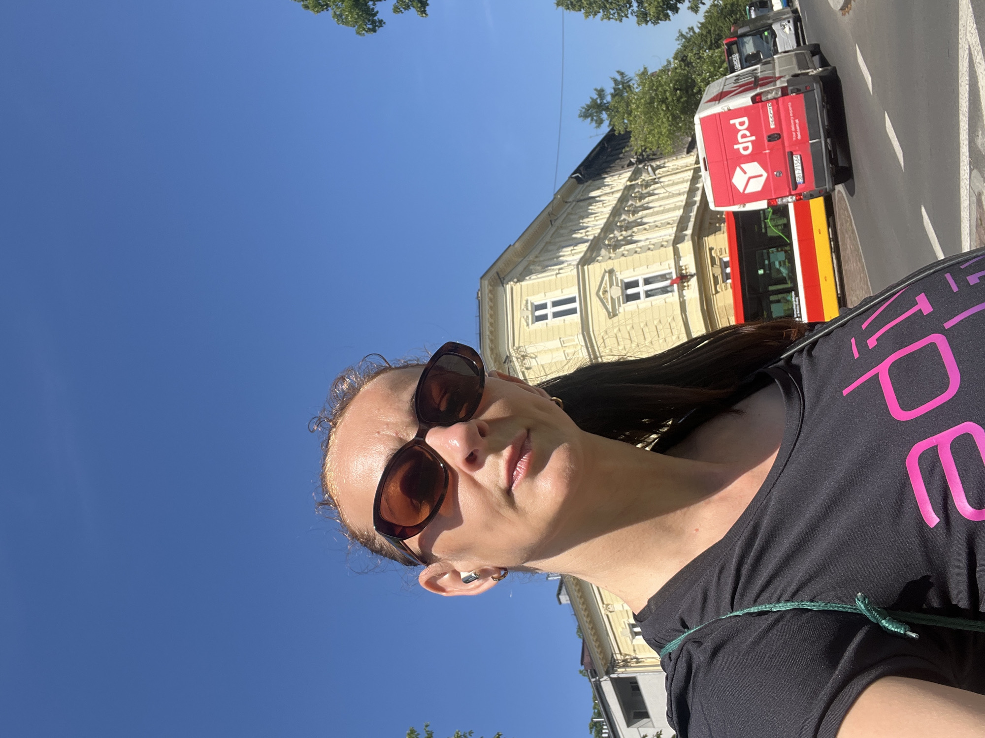 Woman documents sunny morning walk through city streets